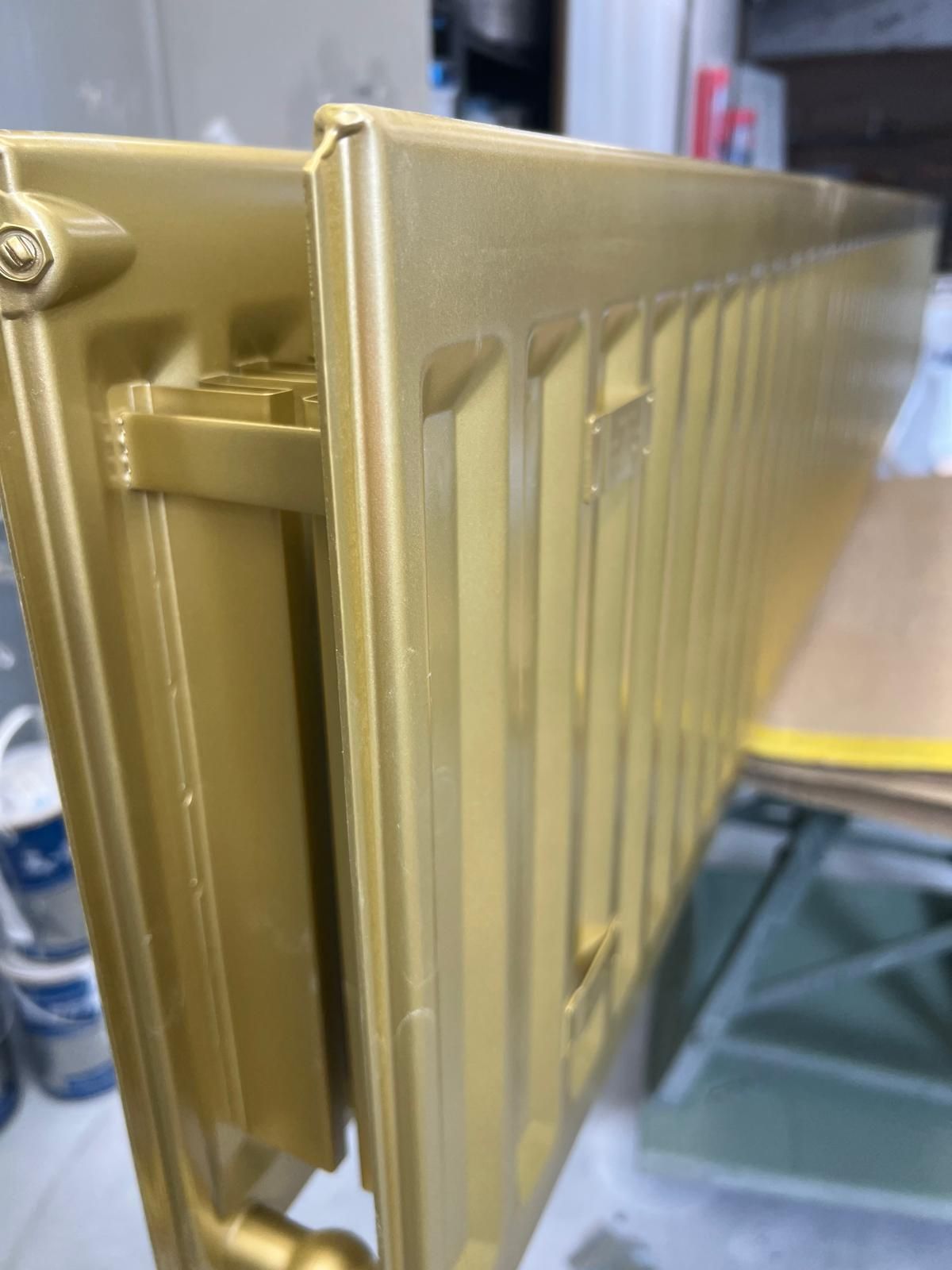 A gold radiator is sitting on top of a wooden table.
