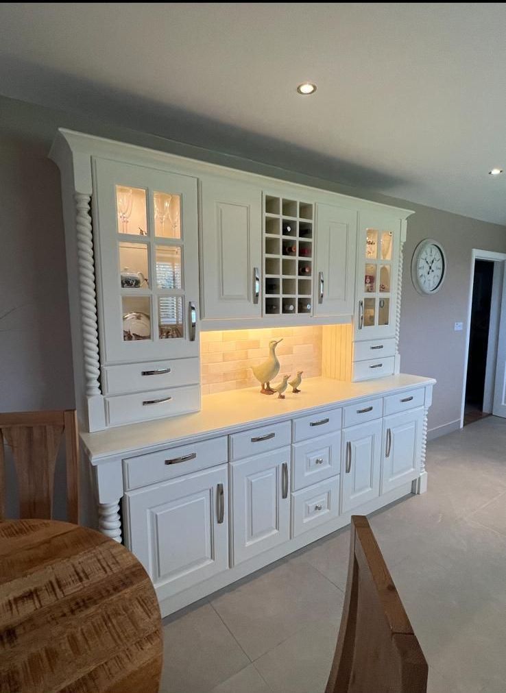 a kitchen with blue cabinets and a stainless steel refrigerator