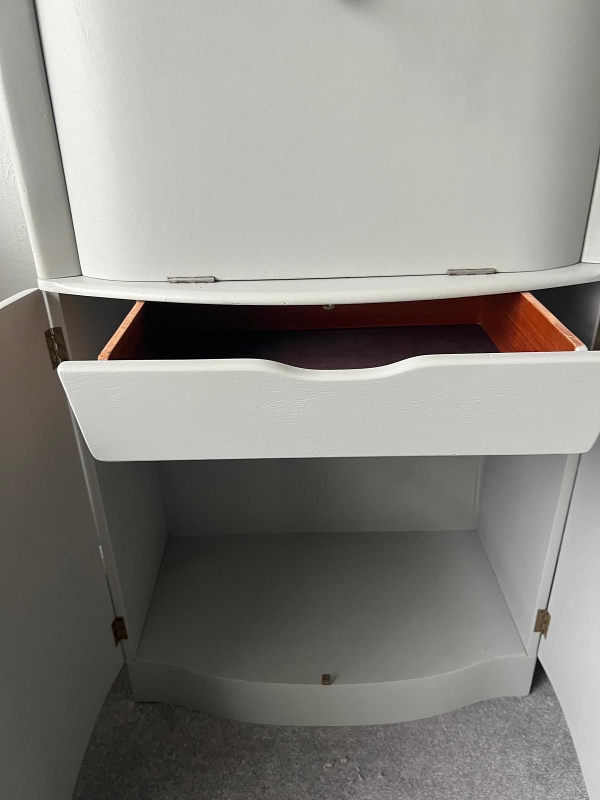 A white drawer with a purple item in it