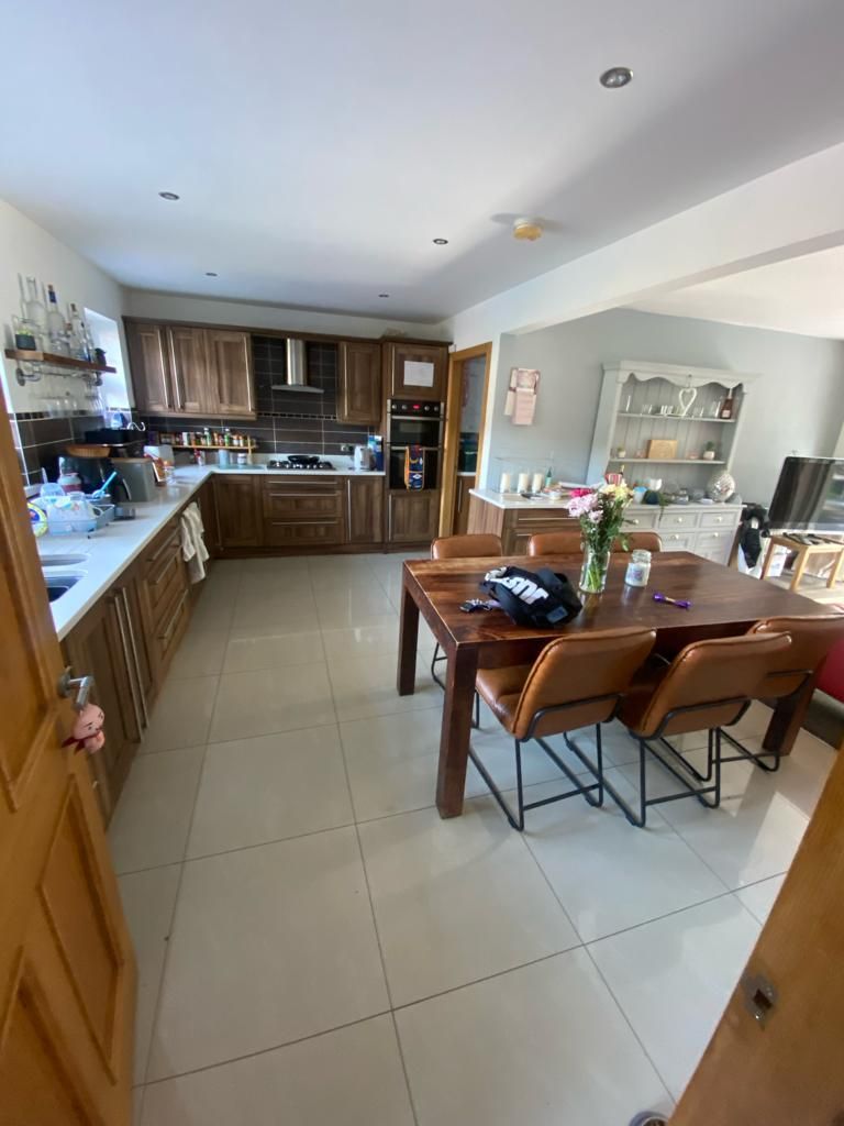 a kitchen with a table and chairs in it .
