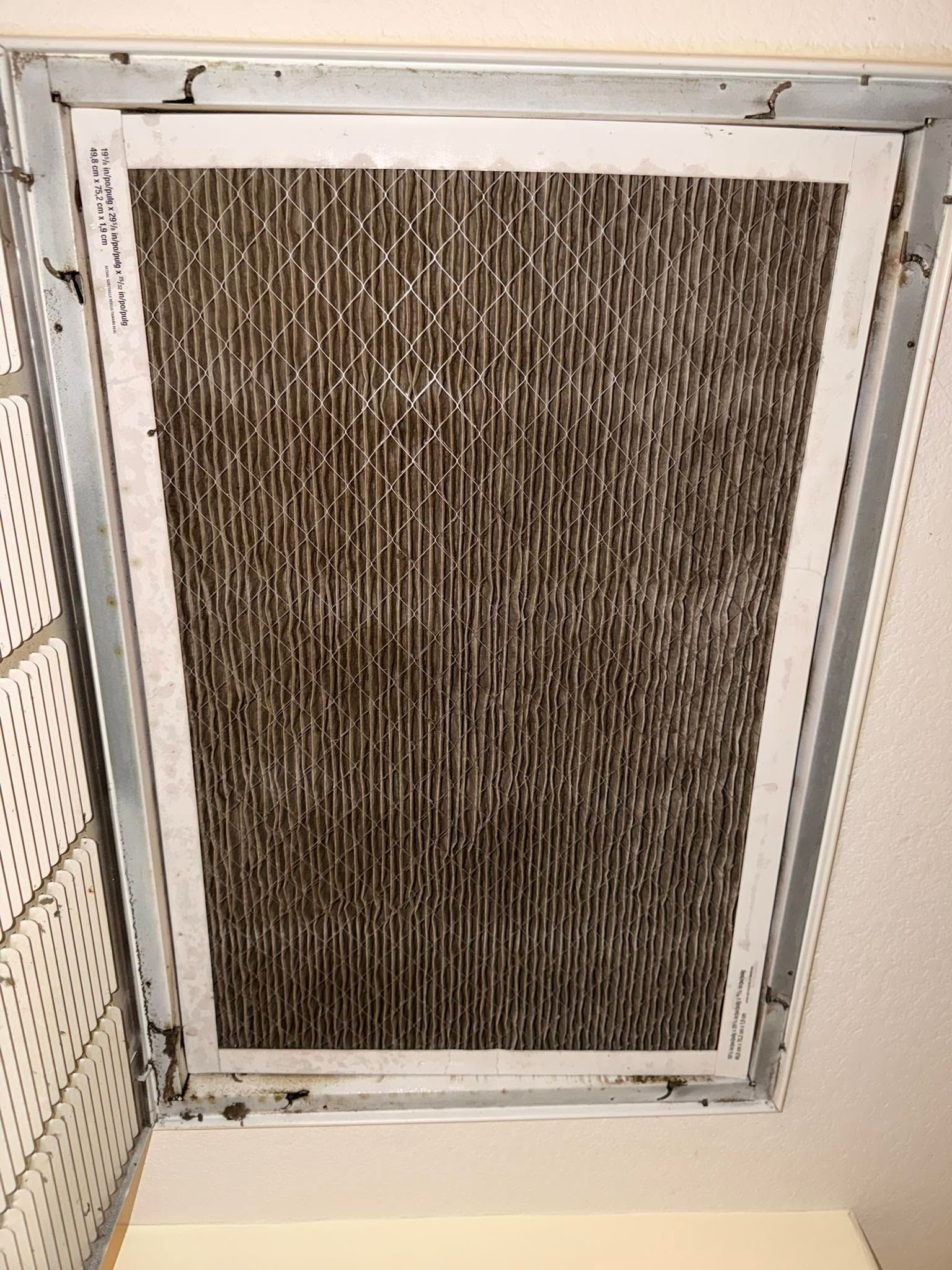 Air conditioning technician servicing an outdoor condenser unit