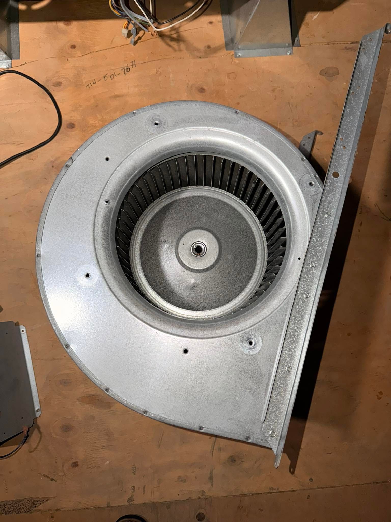 Outdoor HVAC service scene with a gray condenser unit, gauges, and tools on the ground