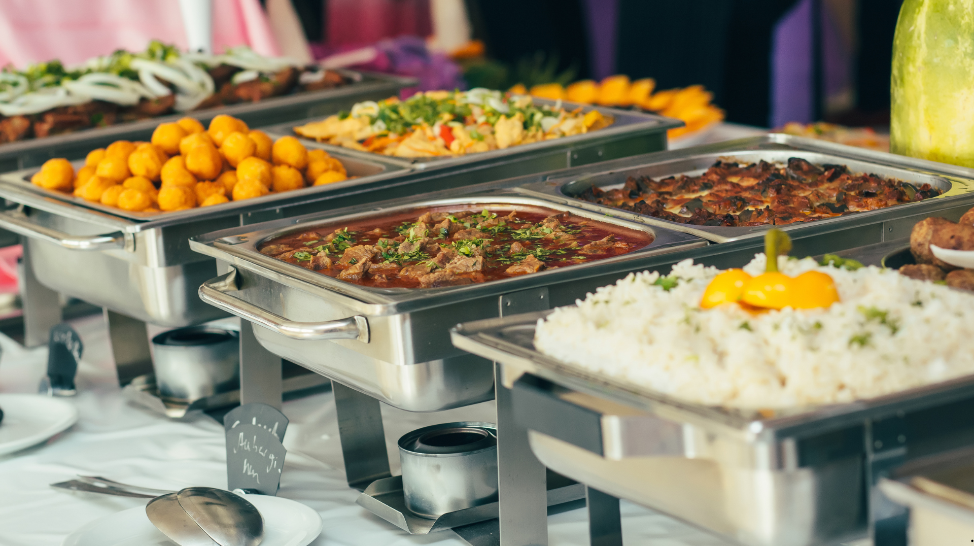 A buffet table filled with lots of different types of food.