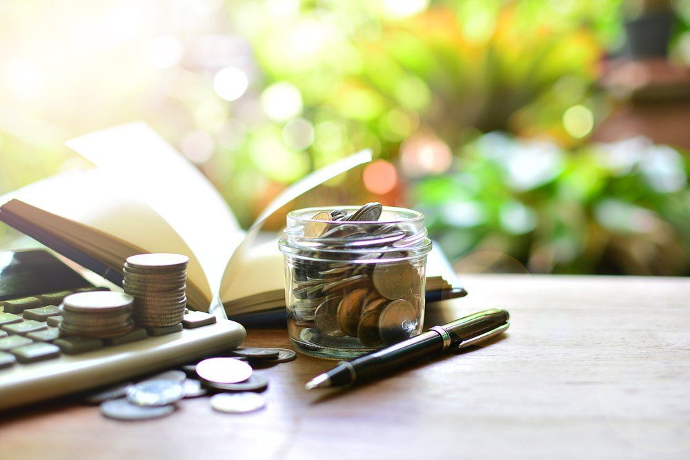 Collection of Coins, Calculator & Pen — Accountants & Bookkeepers in Southern Highlands
