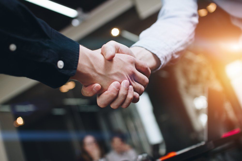 Financial Adviser Shaking Hands With Client — Accountants & Bookkeepers in Southern Highlands