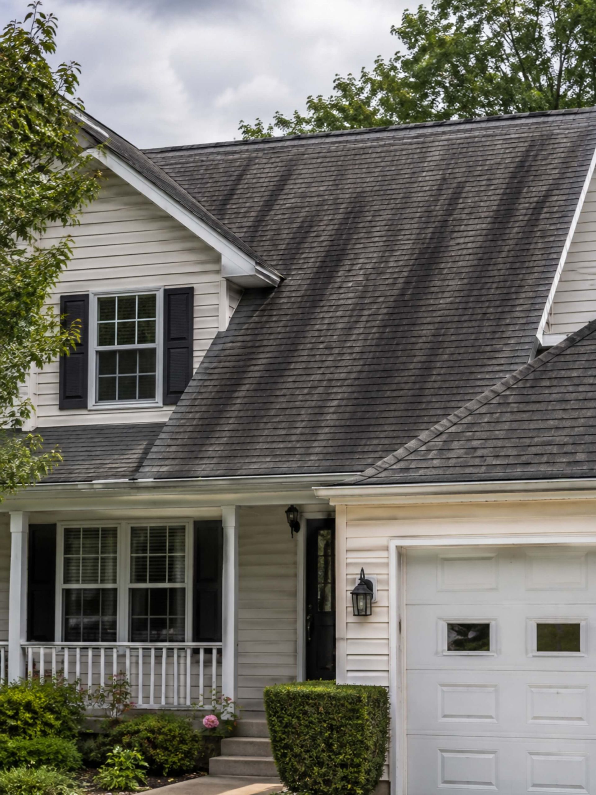 a Wisconsin home with black algae streaks visible across the asphalt shingle roof.