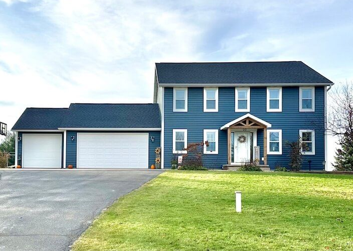 Blue Norandex siding replacement and window shutter removal before and after
