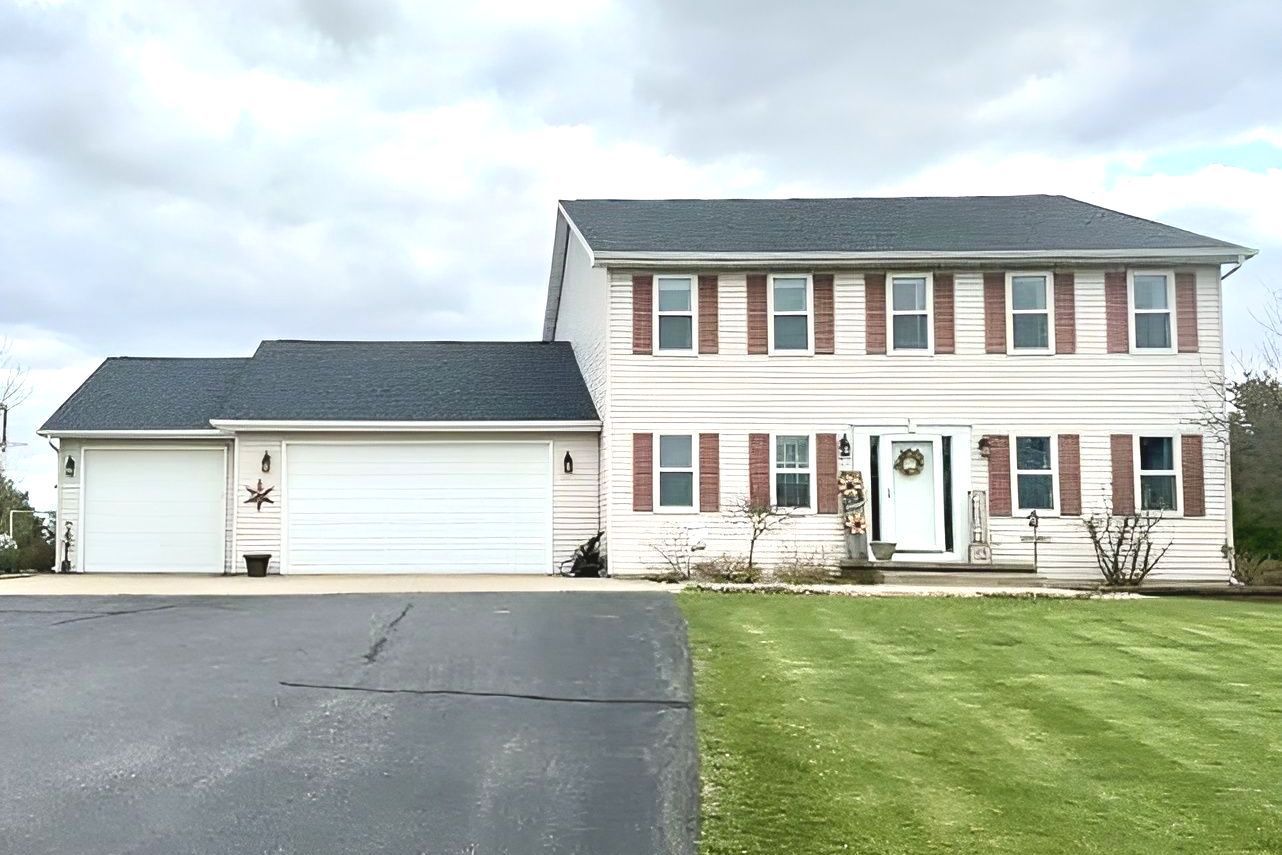 Blue Norandex siding replacement and window shutter removal before and after.
