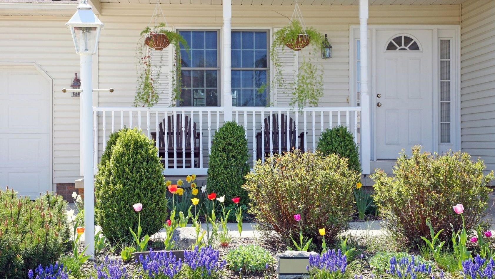 Home remodeling contractor in Waupaca Wisconsin Spring garden growing with daffodils and tulips and hanging flower baskets