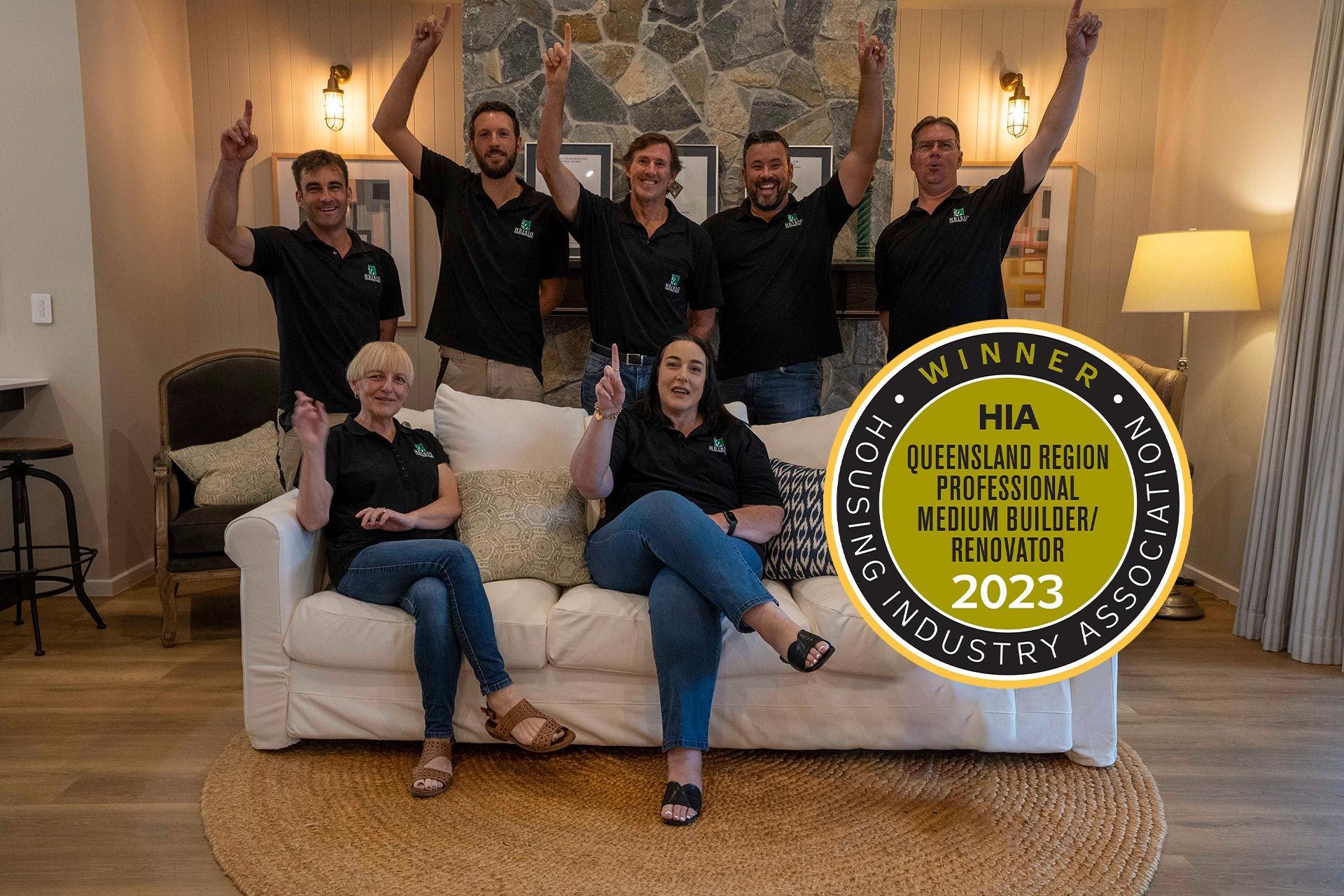a group of people are posing for a picture while sitting on a couch .