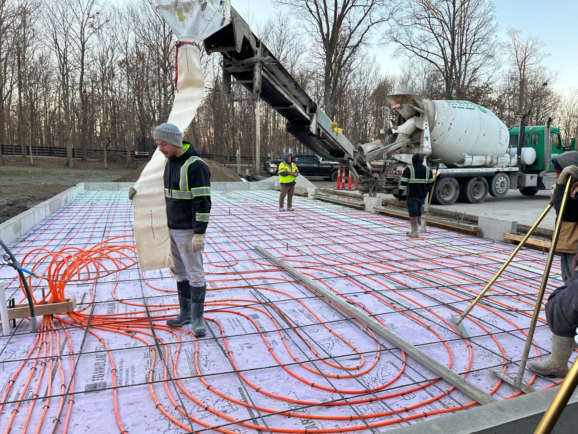 pouring concrete for a heated concrete slab