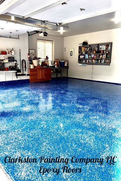 A garage with blue epoxy floors by clarkston painting company llc