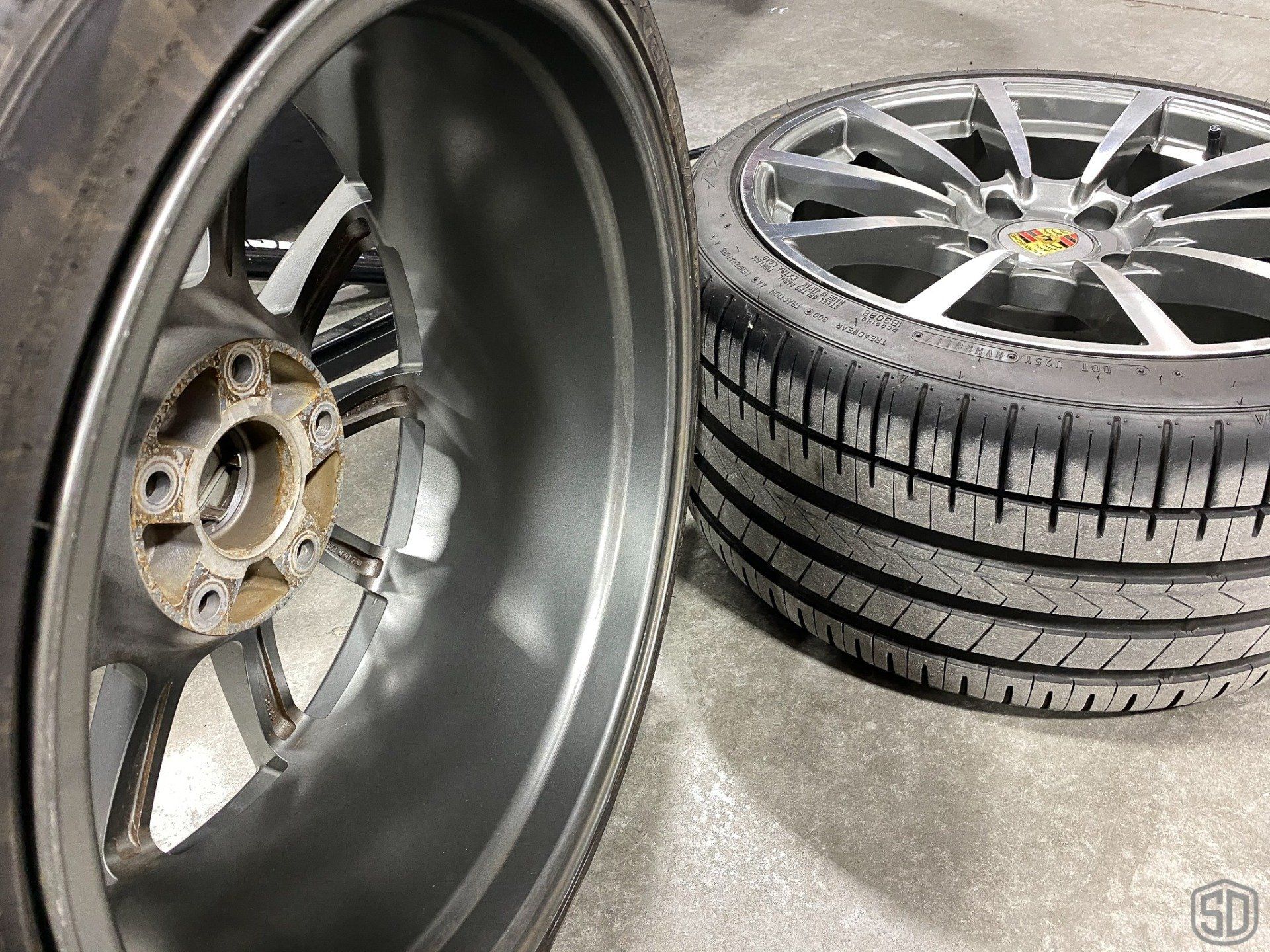 A close up of a car wheel with a tire on top of it.