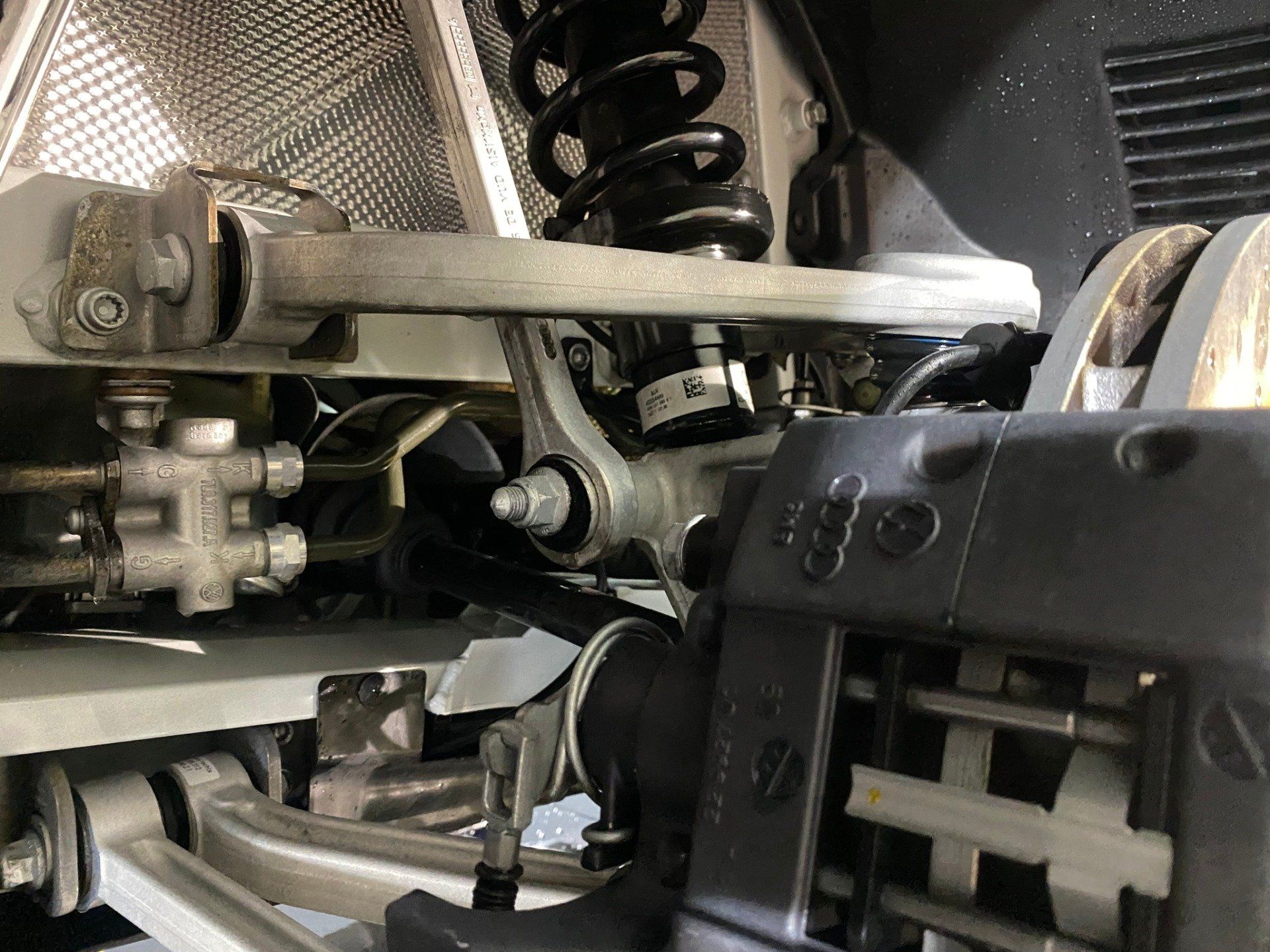 A close up of a car 's suspension and brake system.
