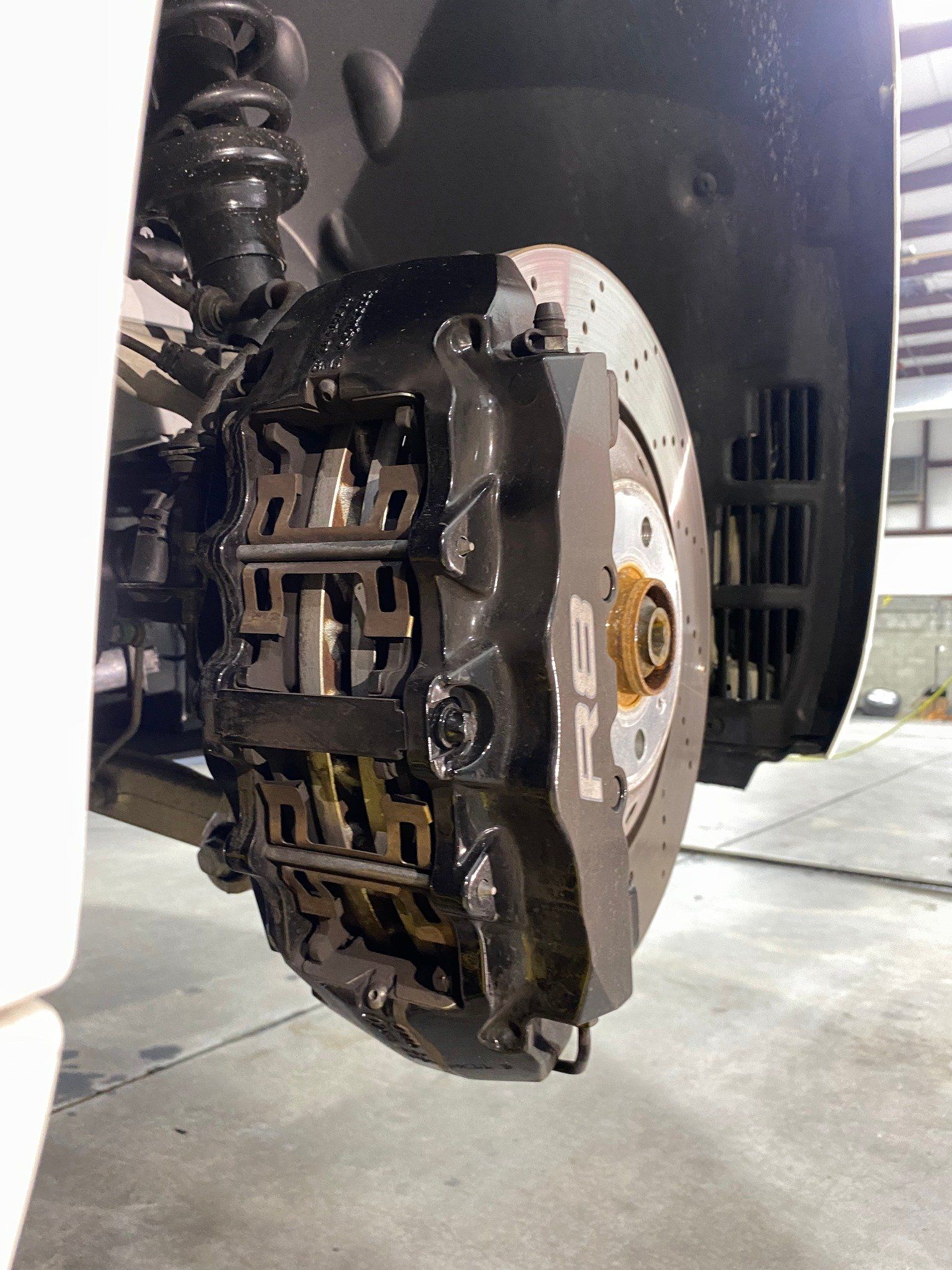 A close up of a brake caliper on a car.