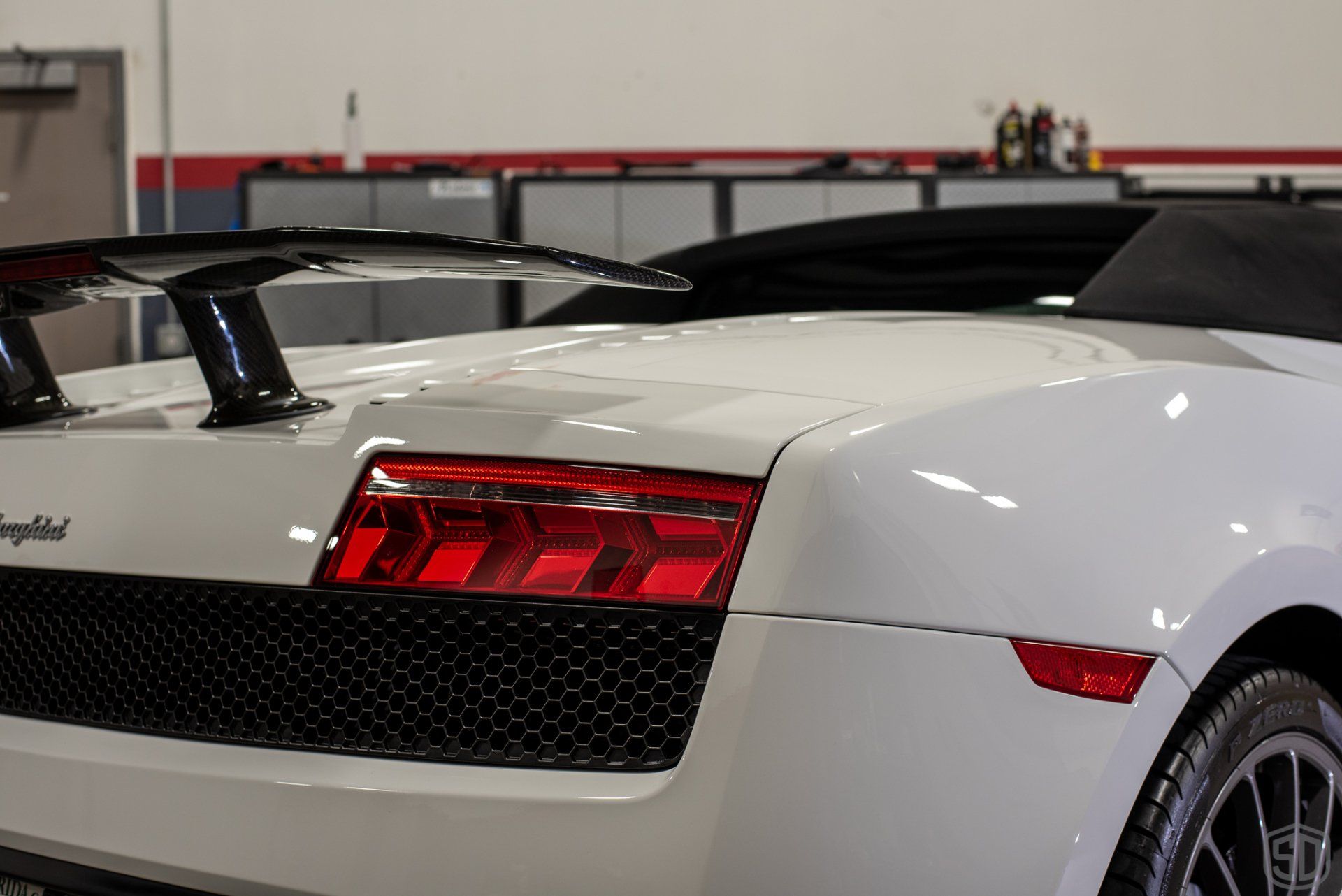 A white lamborghini is parked in a garage