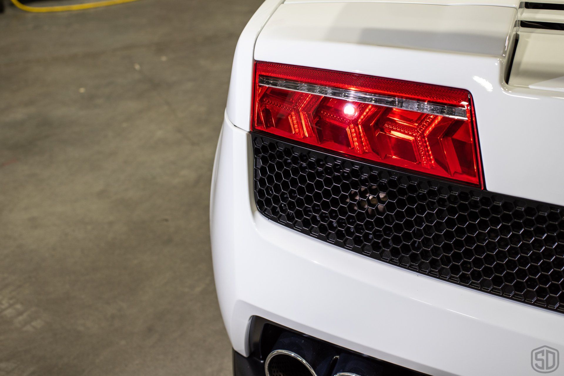 A close up of a white car 's tail light
