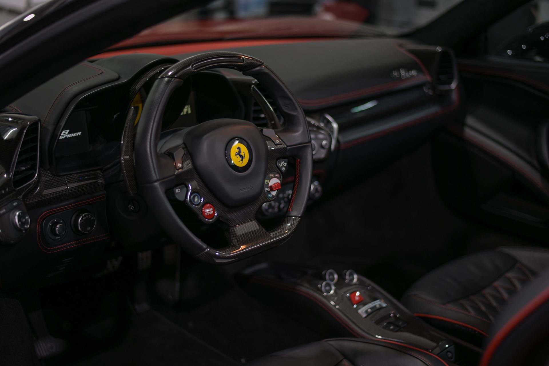 The interior of a ferrari sports car with a steering wheel and dashboard.