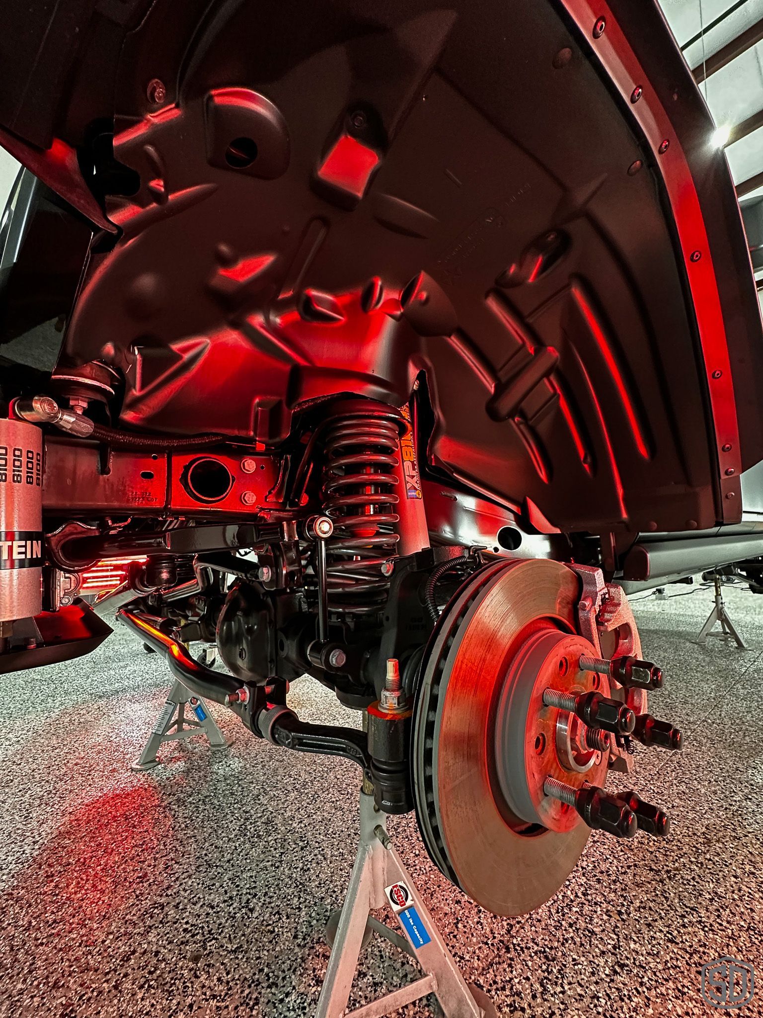 A close up of a car 's suspension and brake system.