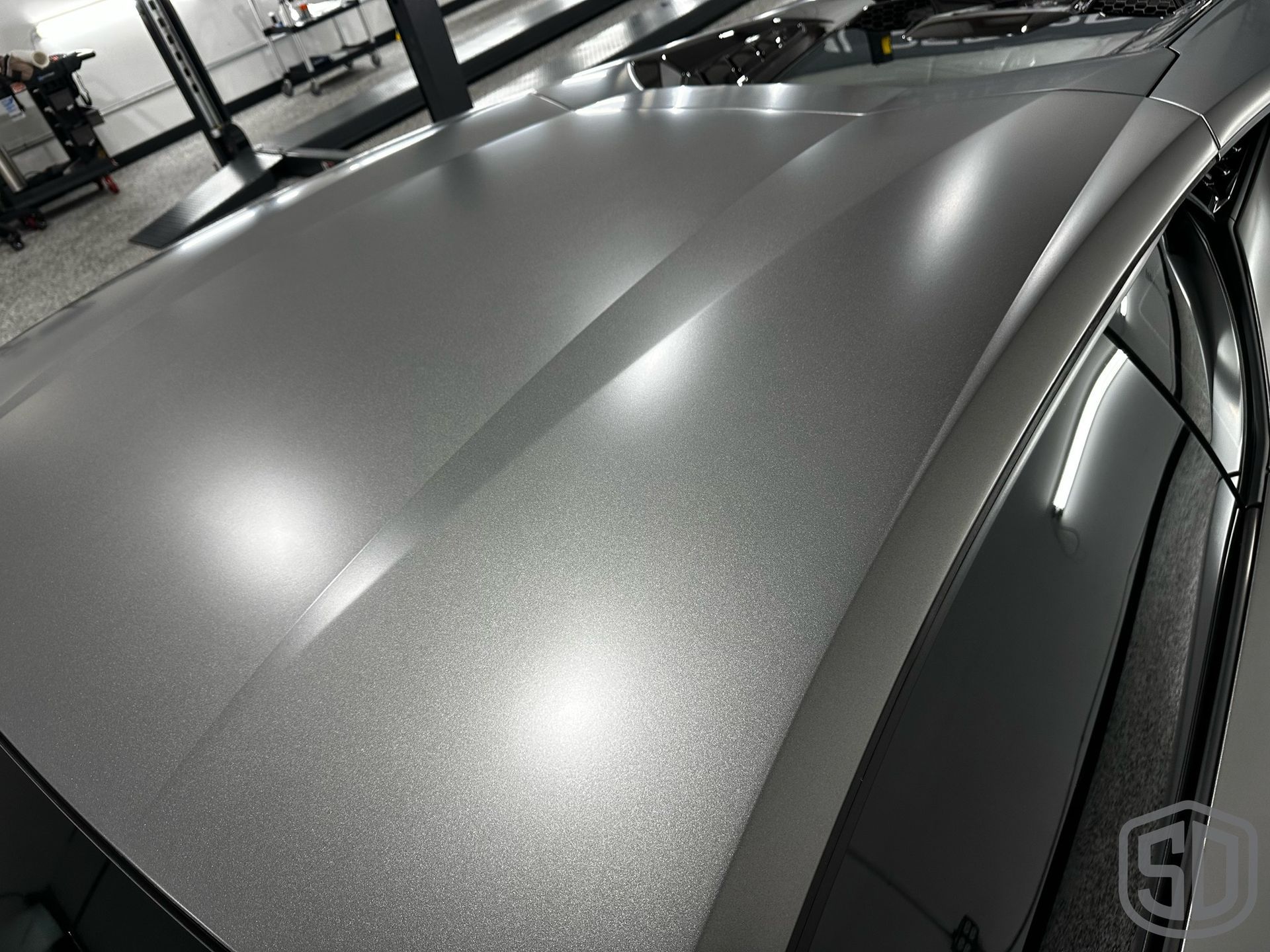 A close up of the roof of a car in a garage.