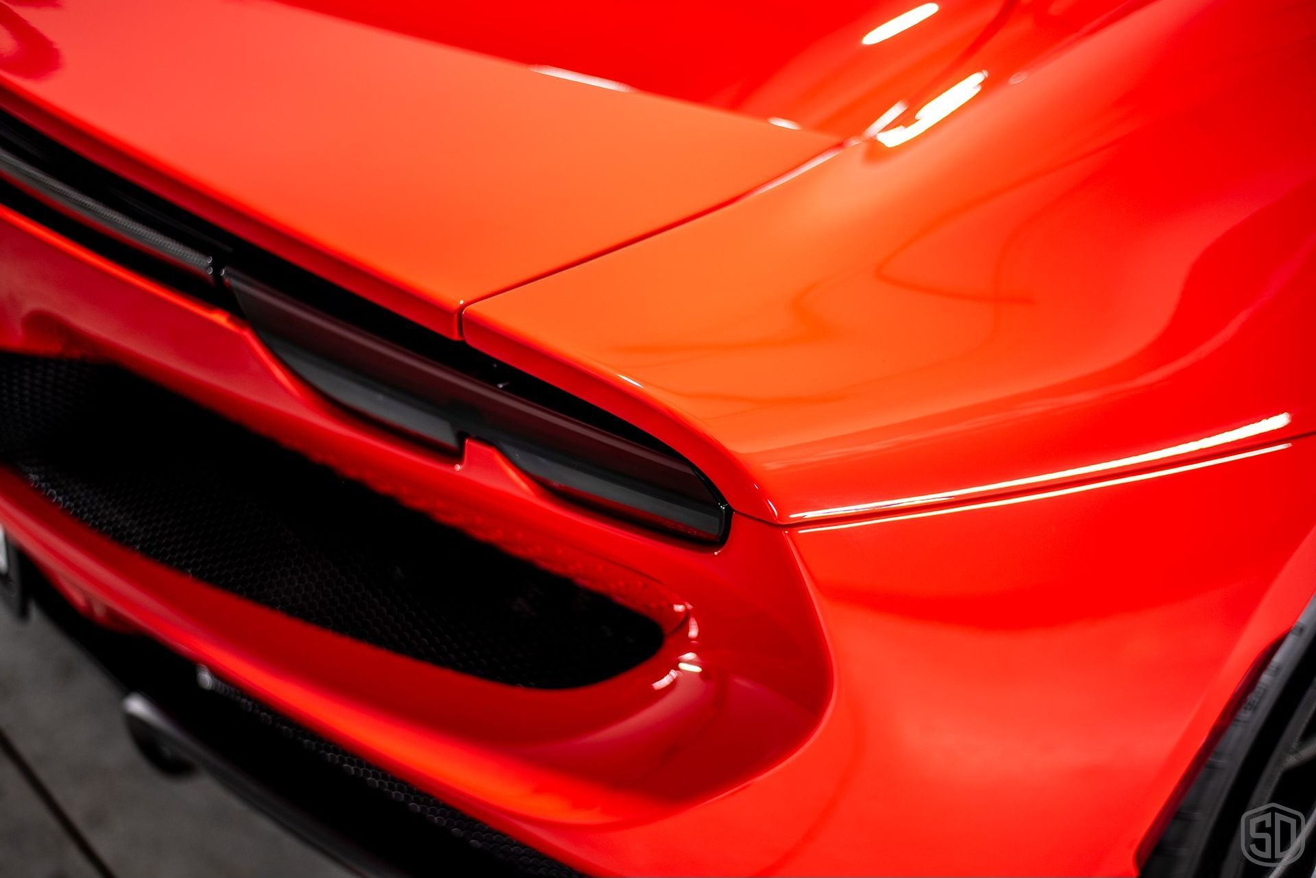 A close up of the front of a red car