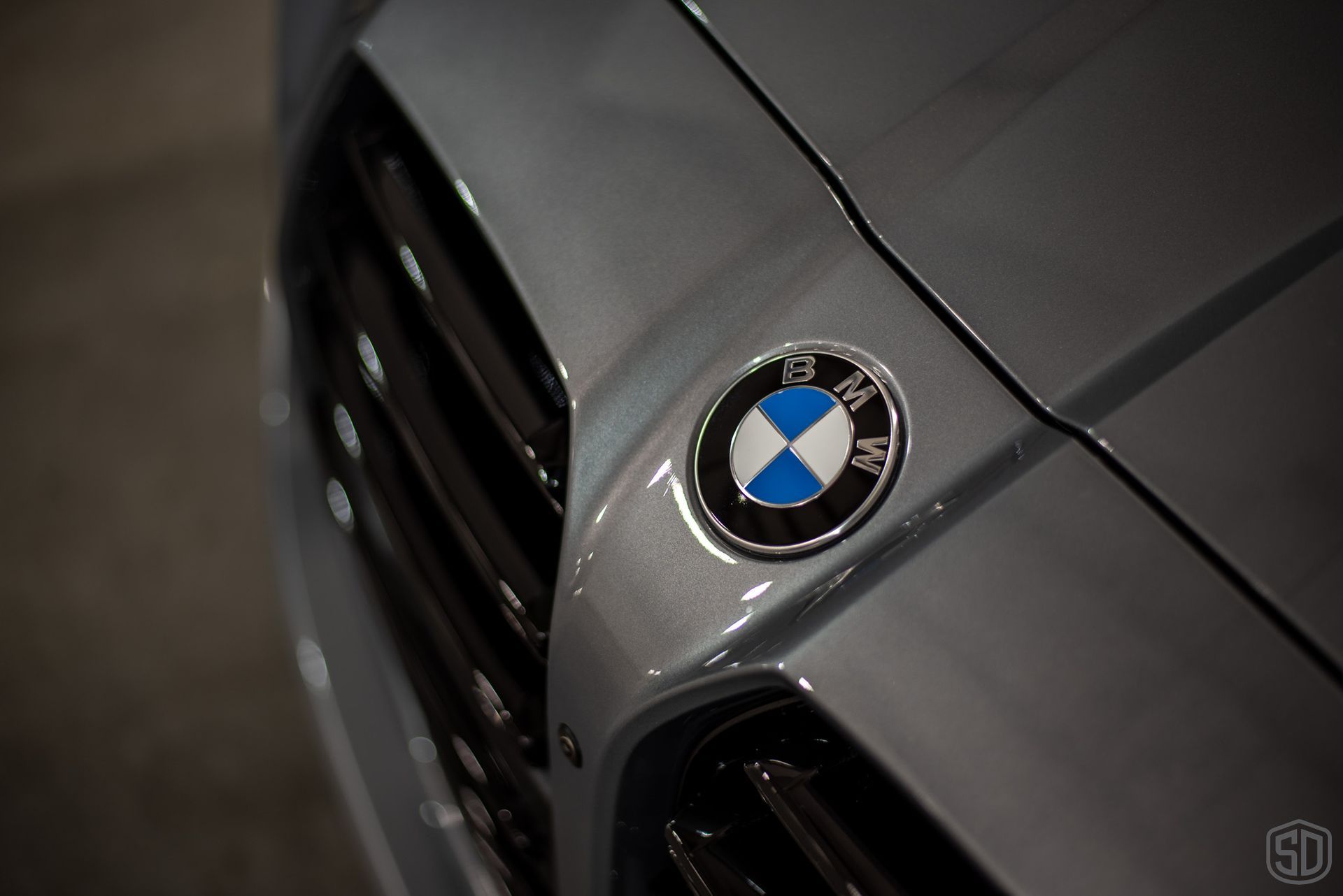 A close up of a bmw emblem on the front of a car