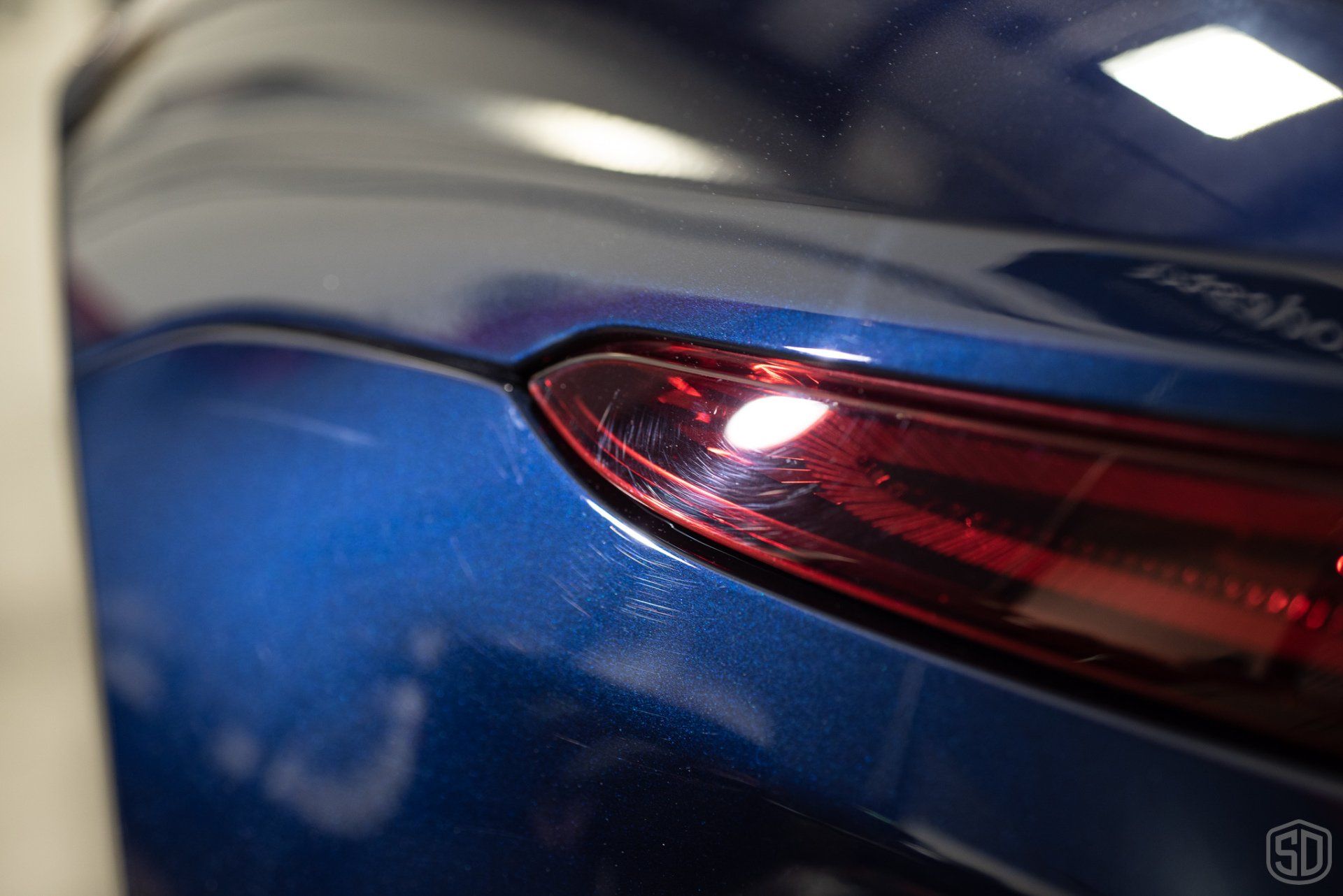 A close up of a blue car 's tail light.