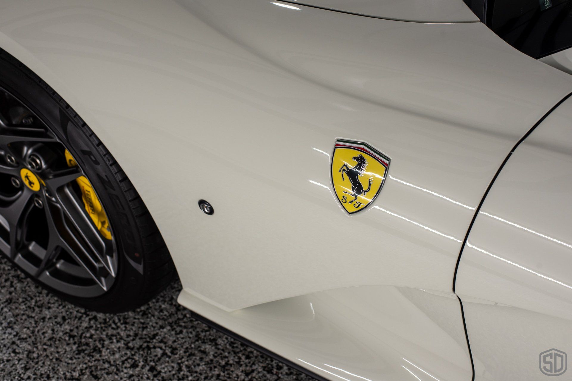 Bianco Avus Ferrari 812 Superfast Detailing, Modesta Primer, Wheel and Caliper Detailing, Interior Conditioning , PPF, Modesta BC-04 Nano-Titanium Glass Coating, and Much More emblem detail close upOrlando