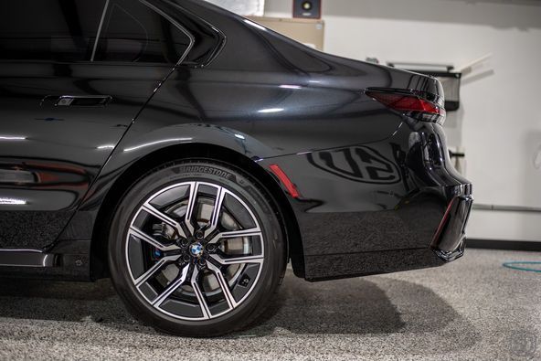 A black car is parked in a garage.
