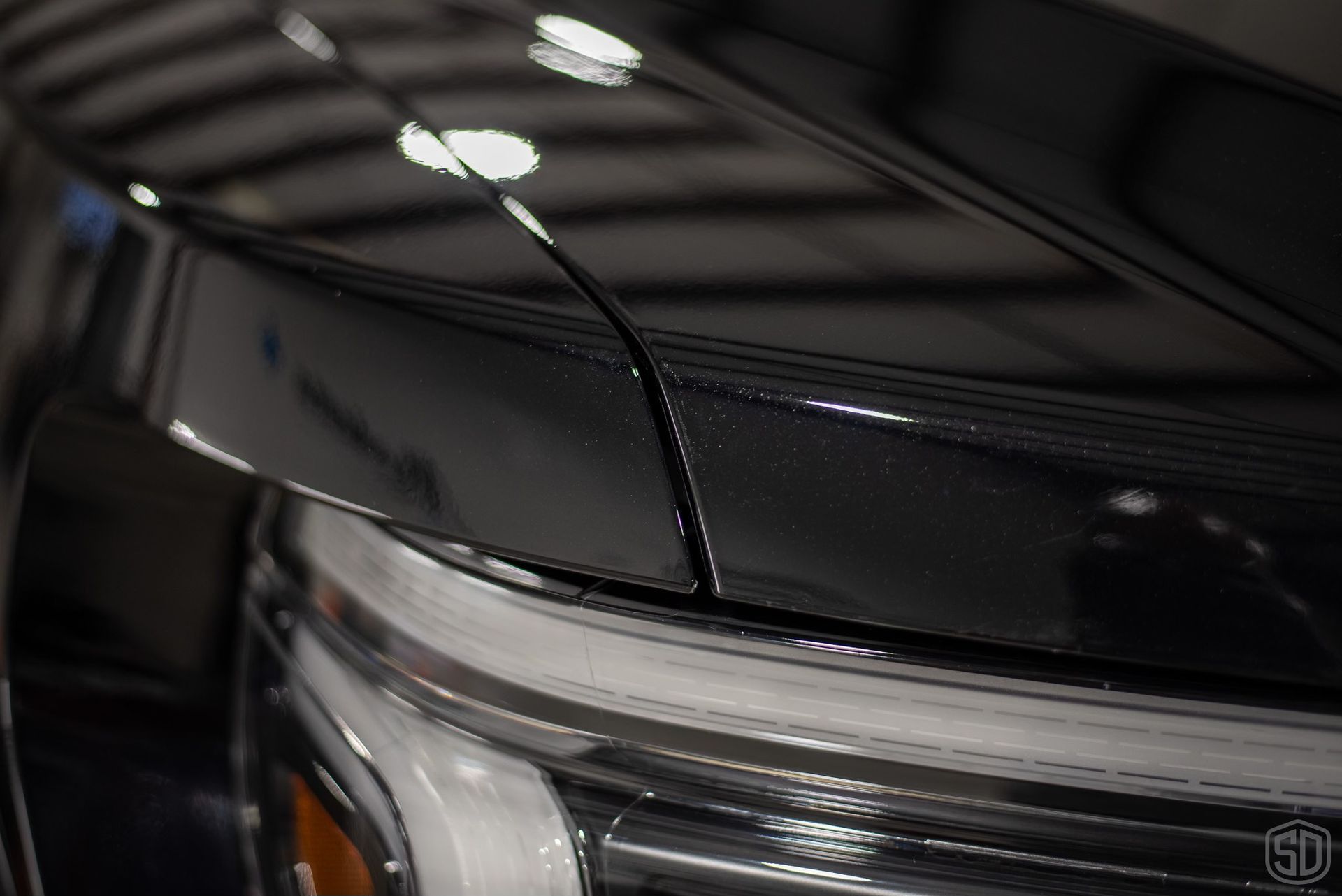 A close up of the hood of a black car