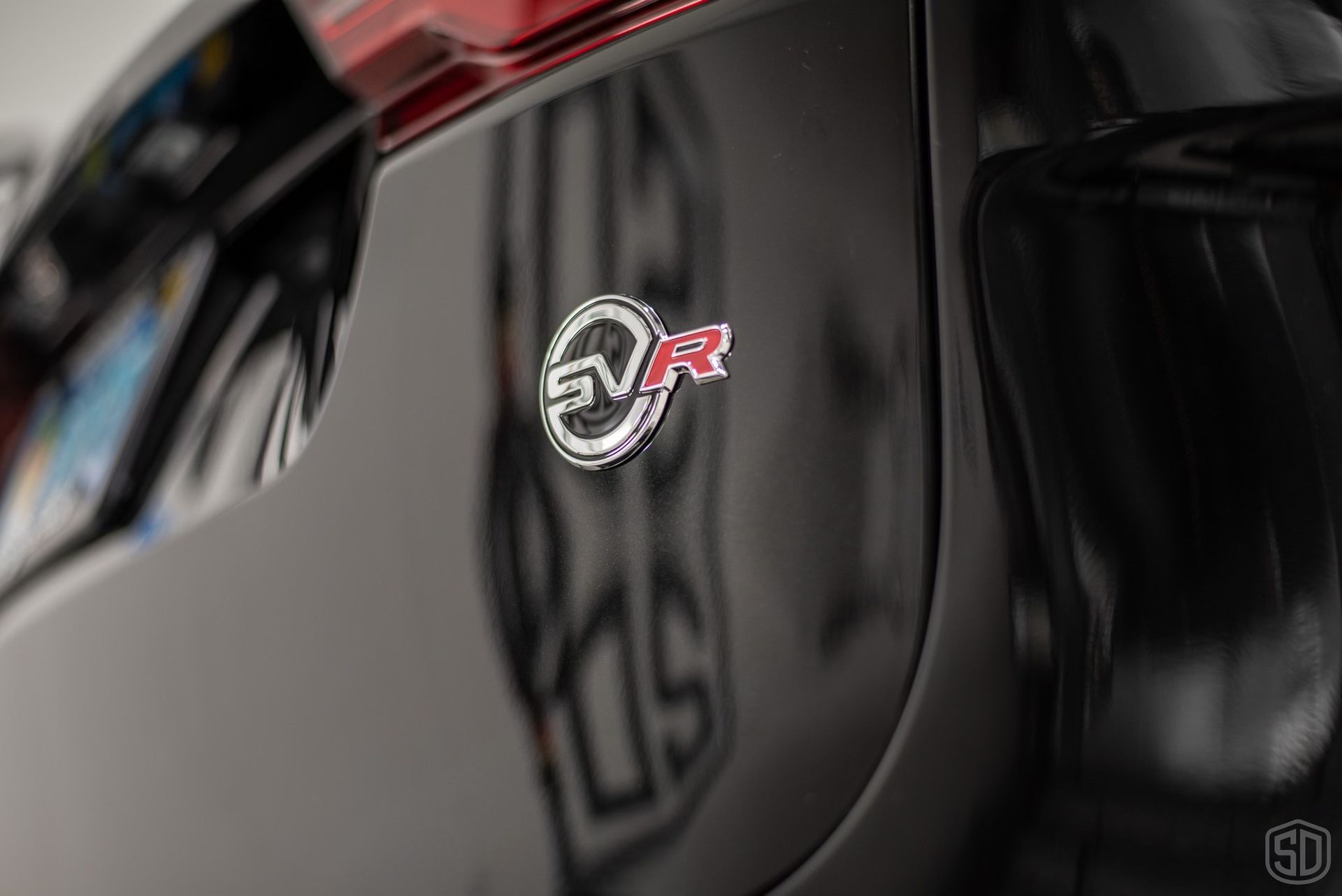 A black car with a sticker on the side that says svr