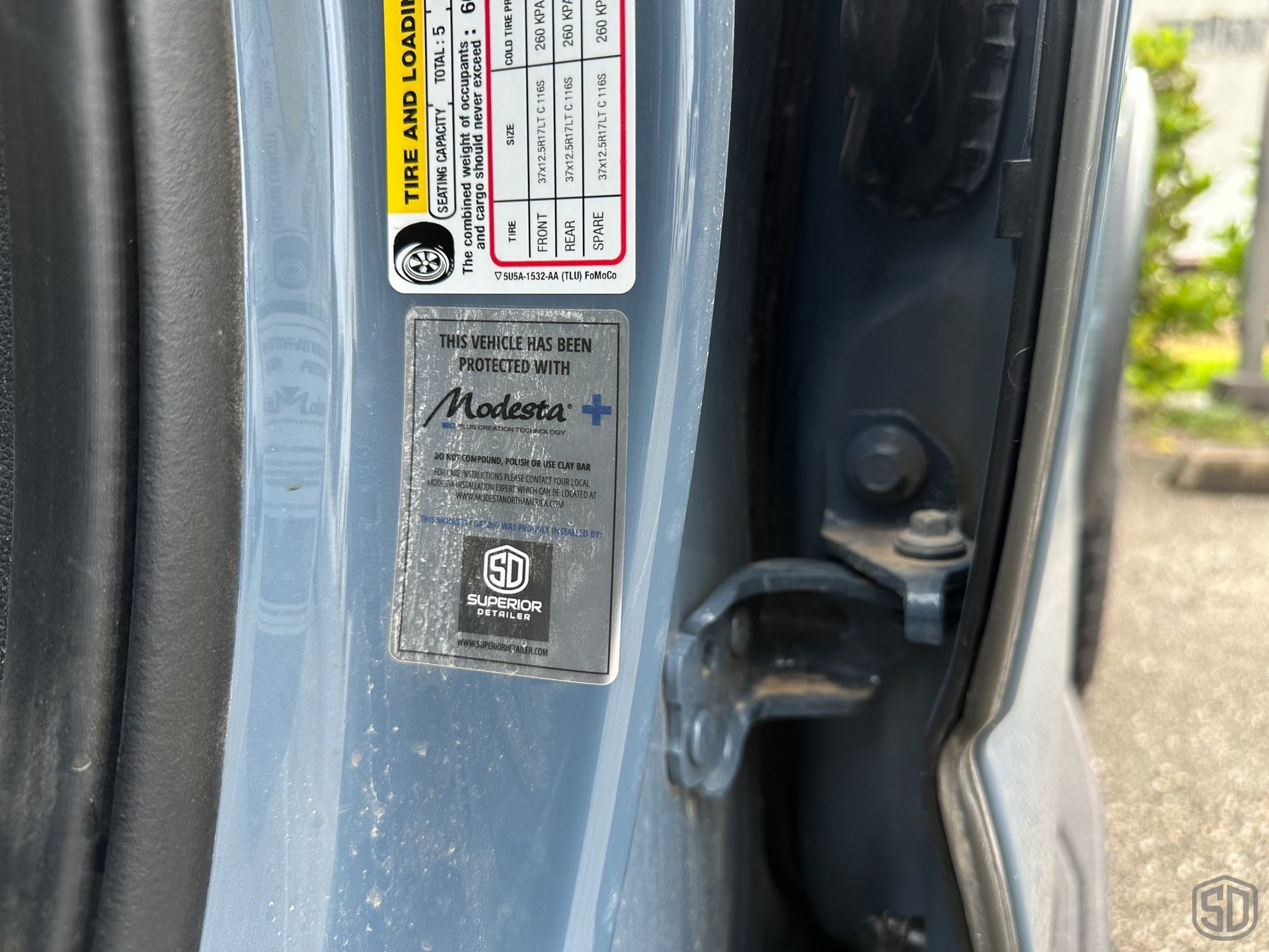 A close up of a car door with a sticker on it