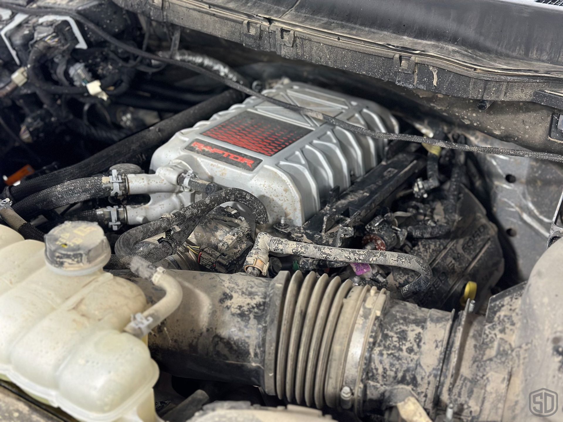 A close up of a dirty engine in a car