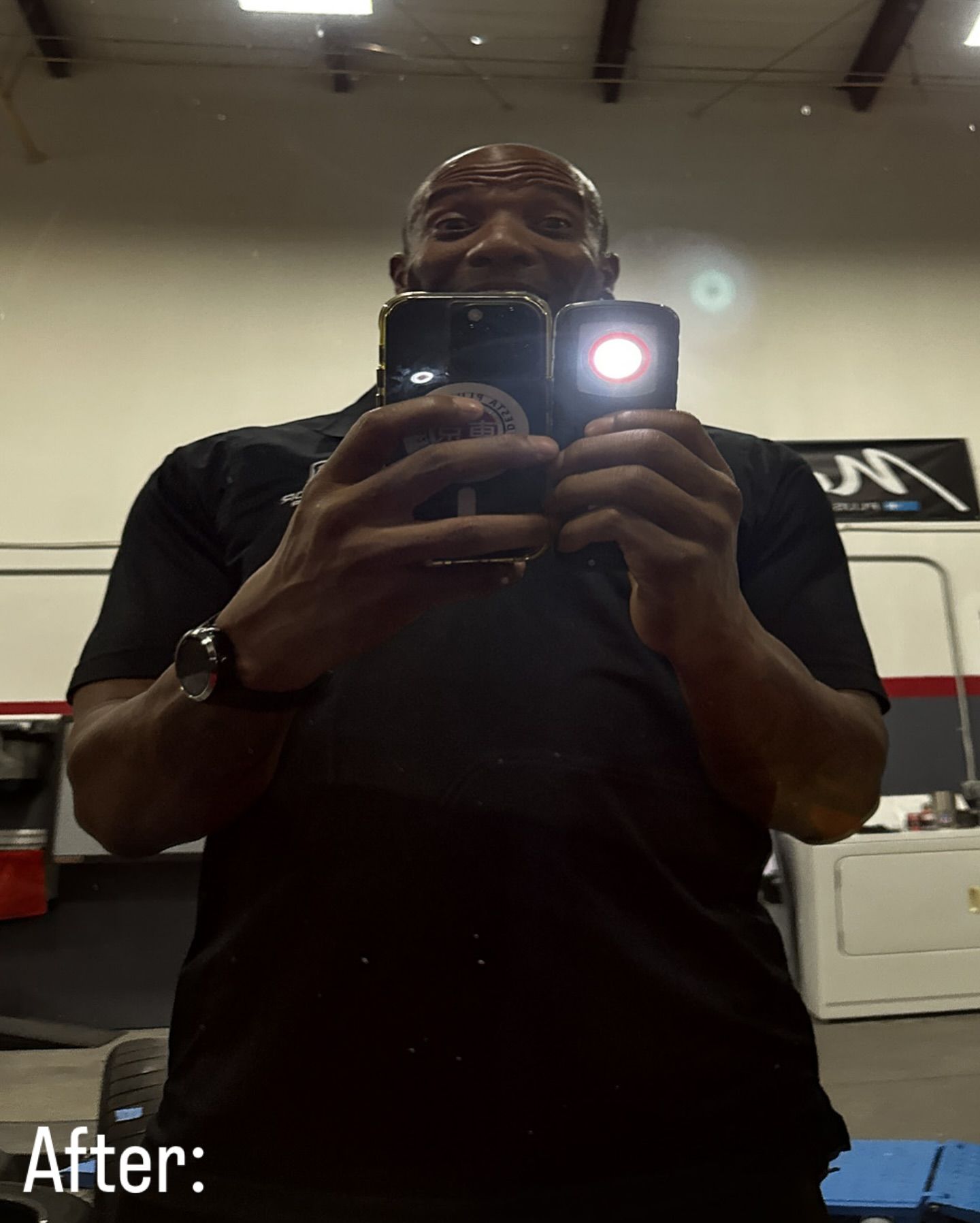 A man taking a picture of himself with a flashlight