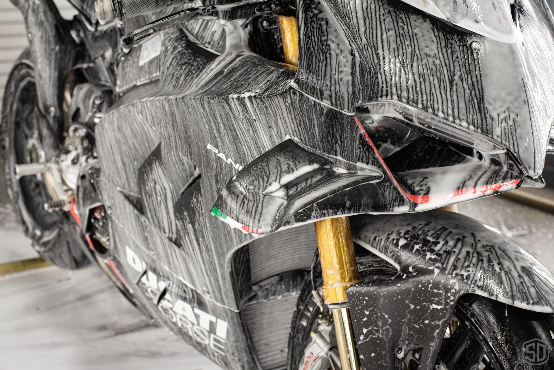 A close up of a motorcycle covered in foam.