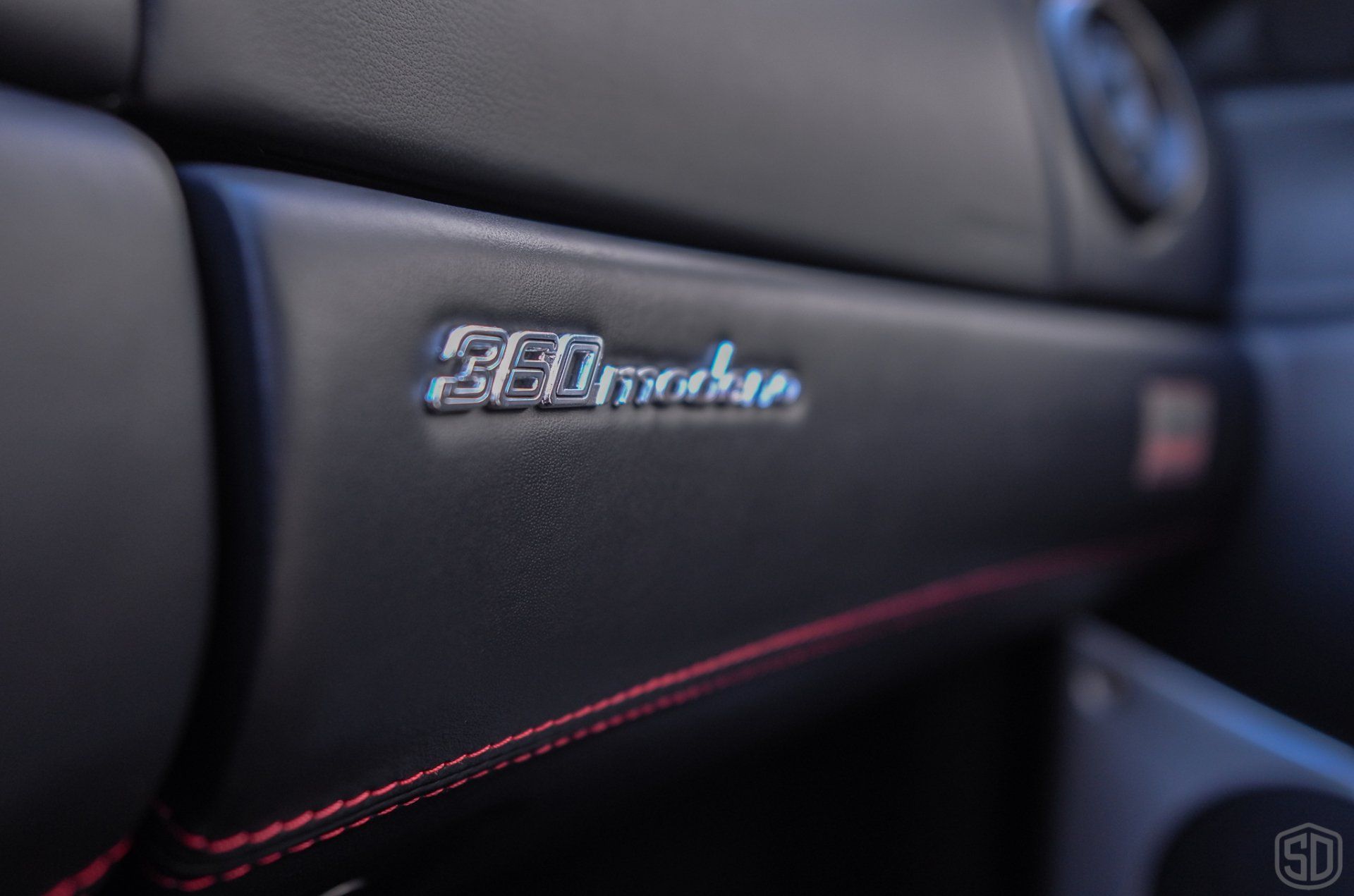 A close up of a car dashboard with a ferrari logo on it