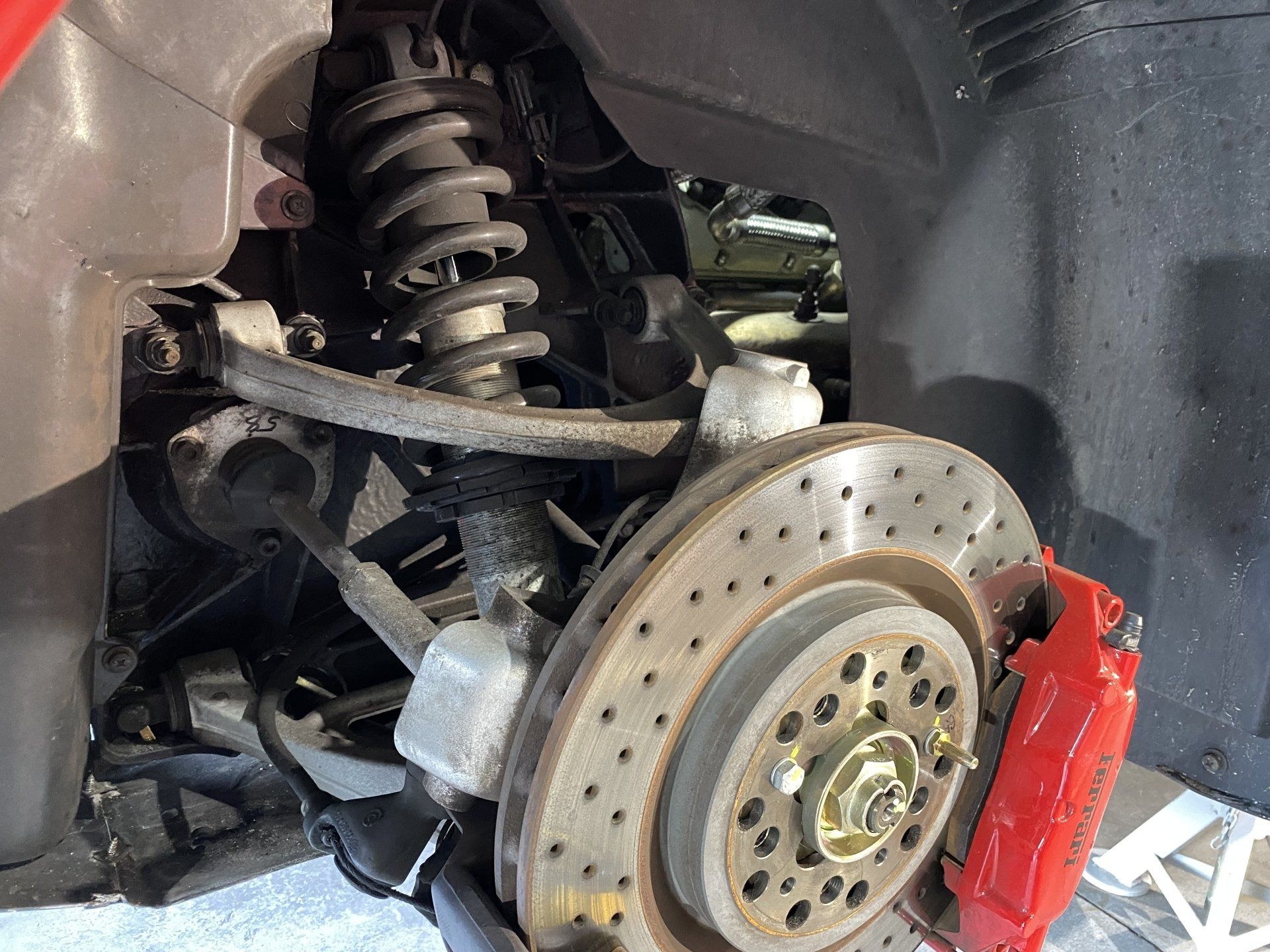 A close up of a car 's suspension and brake system.