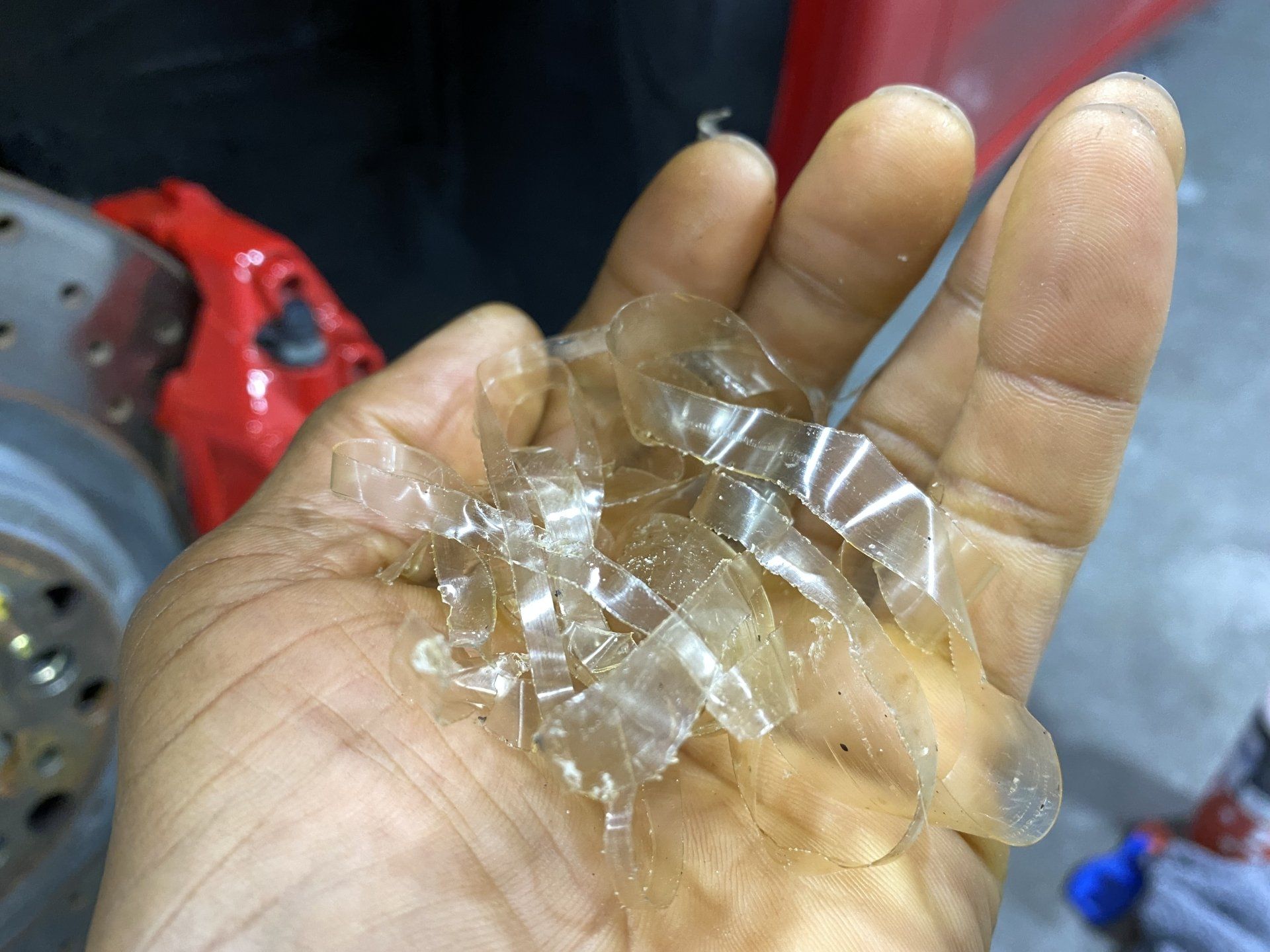 A person is holding a pile of plastic pieces in their hand