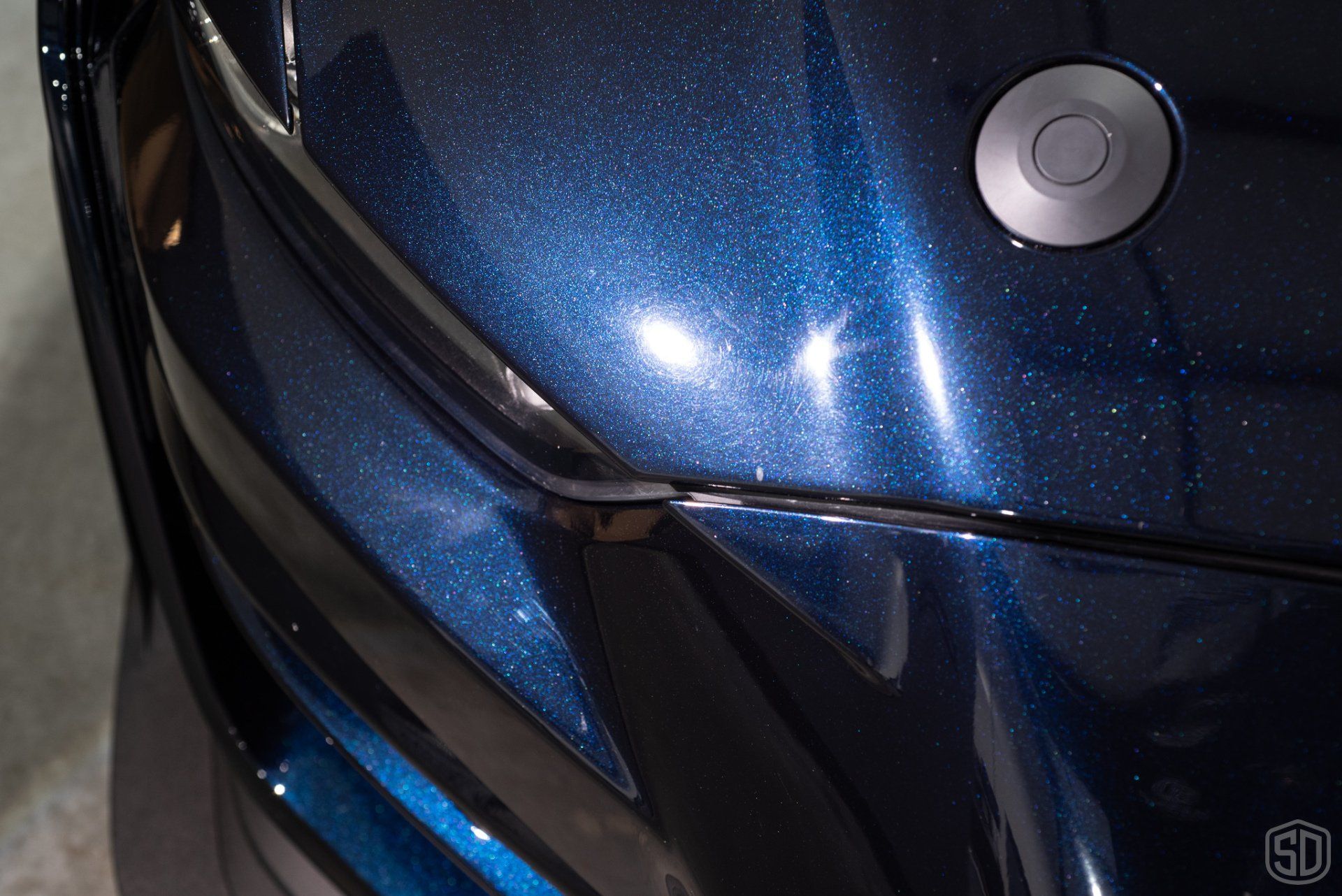 A close up of the hood of a blue car