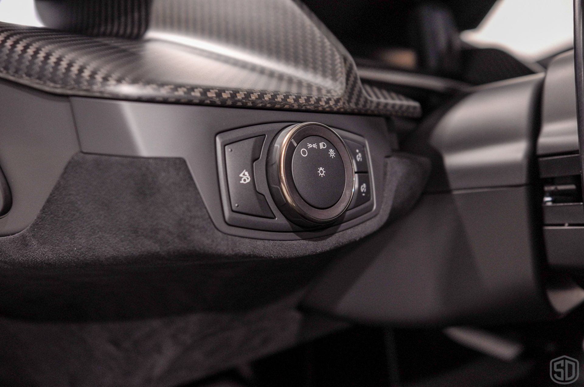 A close up of a car 's steering wheel and controls