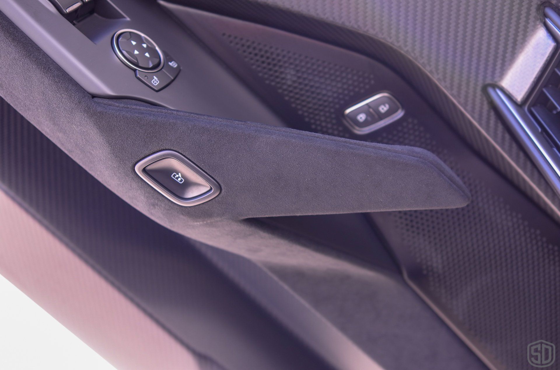 A close up of a car door handle with buttons on it