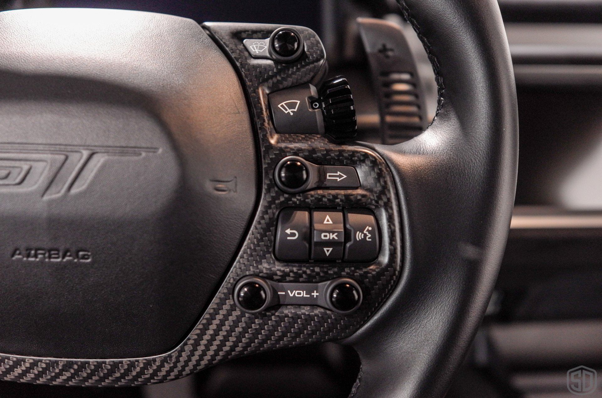 A close up of the steering wheel of a car