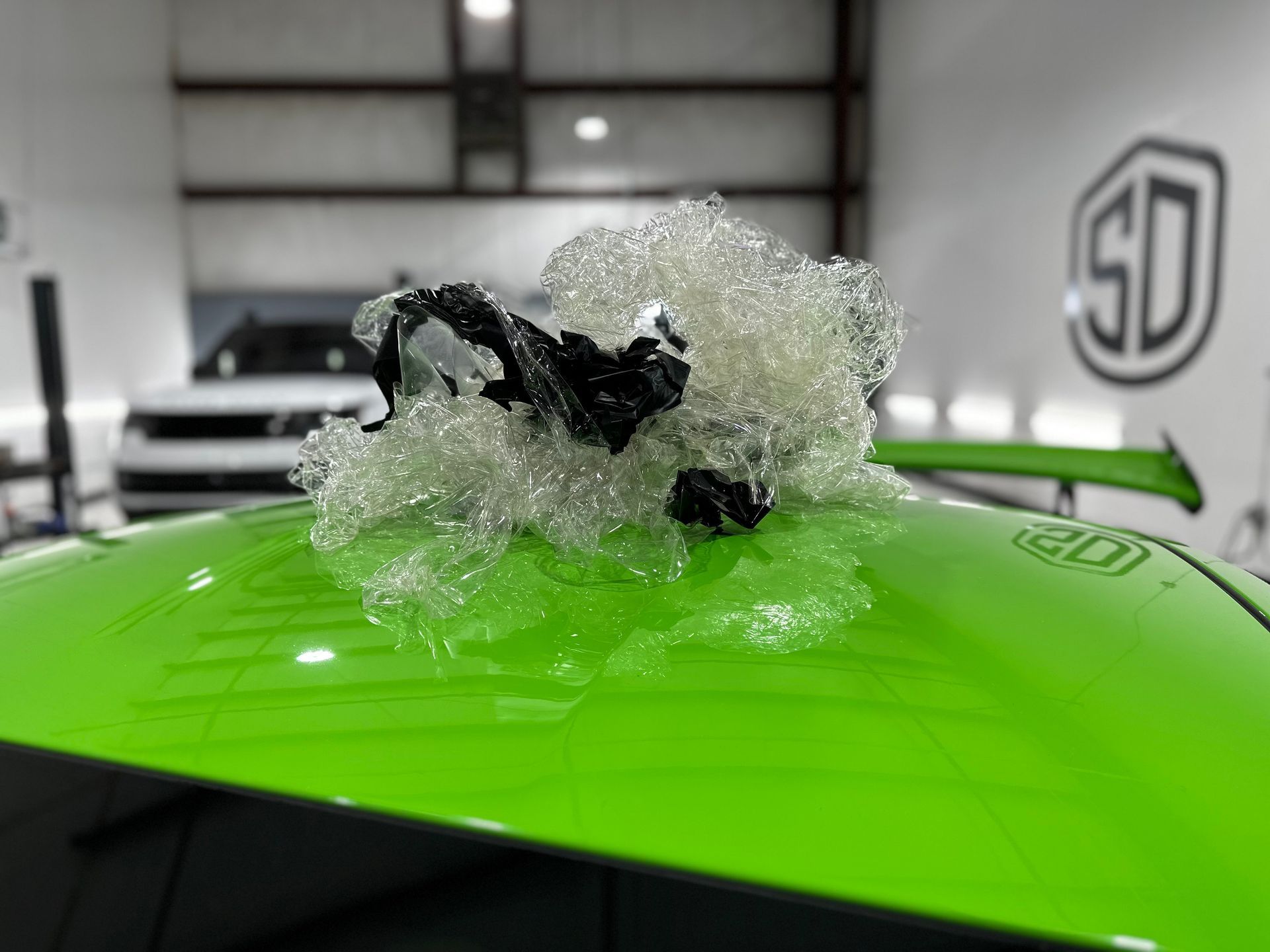 A green car with a lot of bubbles on the roof.