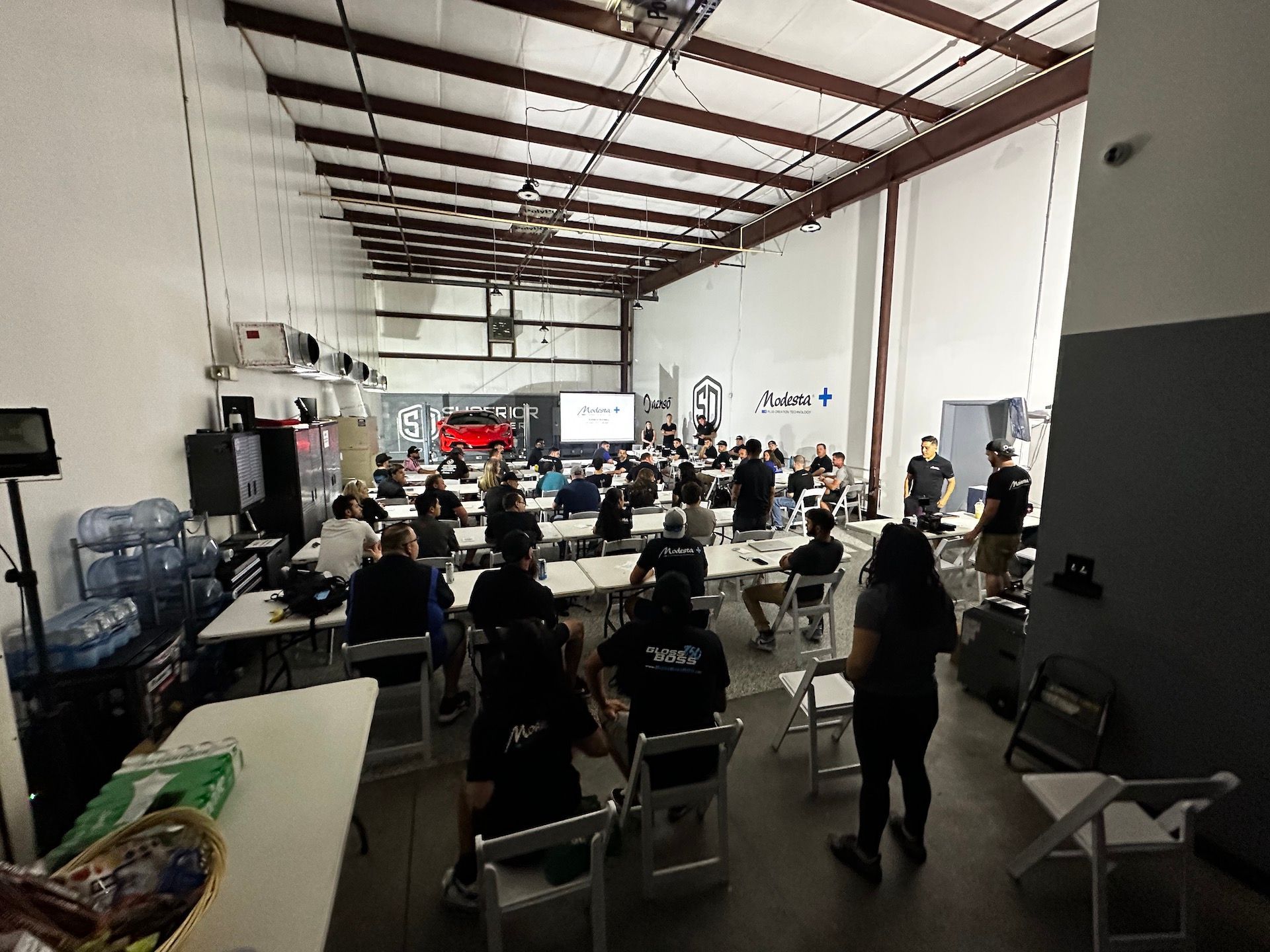 A large group of people are sitting at tables in a large room.