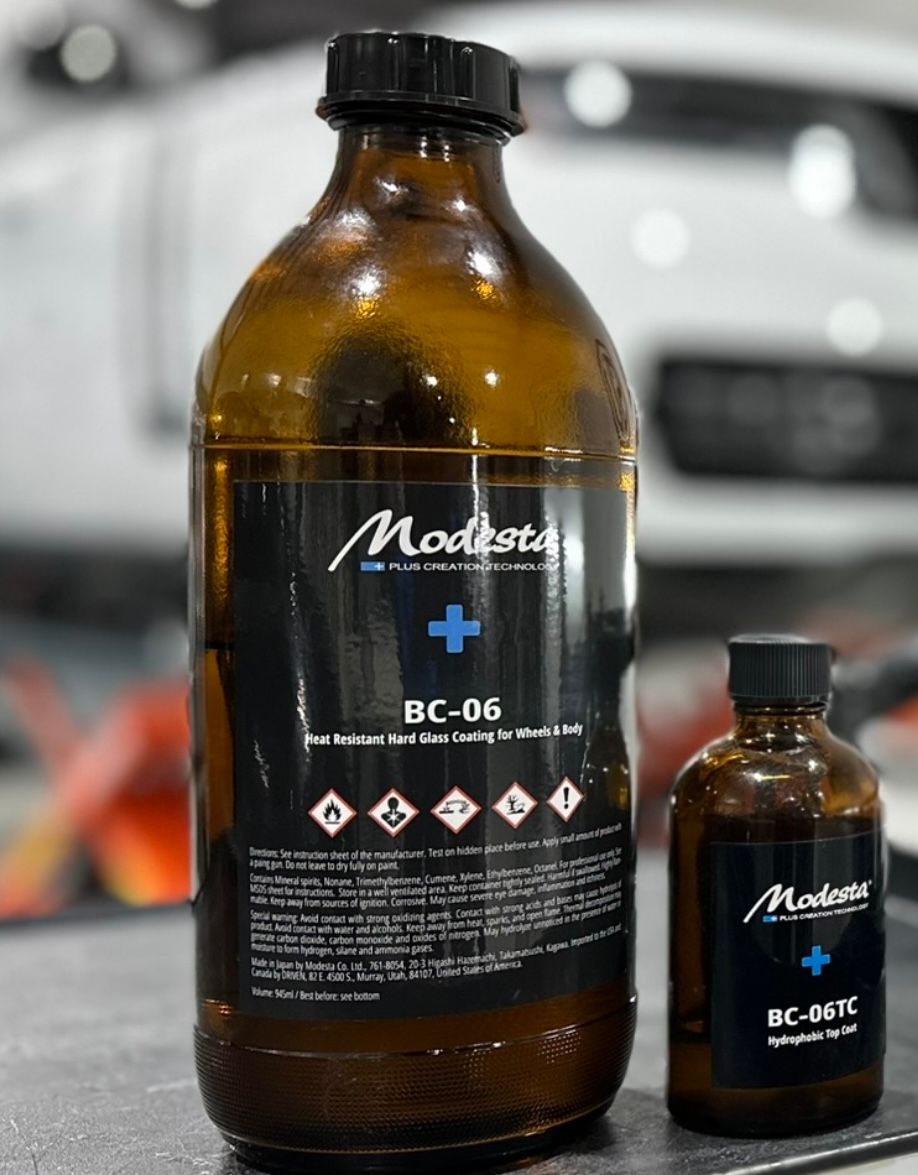 A bottle of moderate bc-06 sits next to a smaller bottle