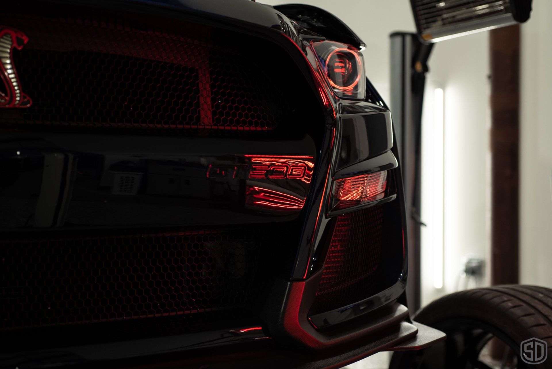 A close up of the back of a car with red lights.