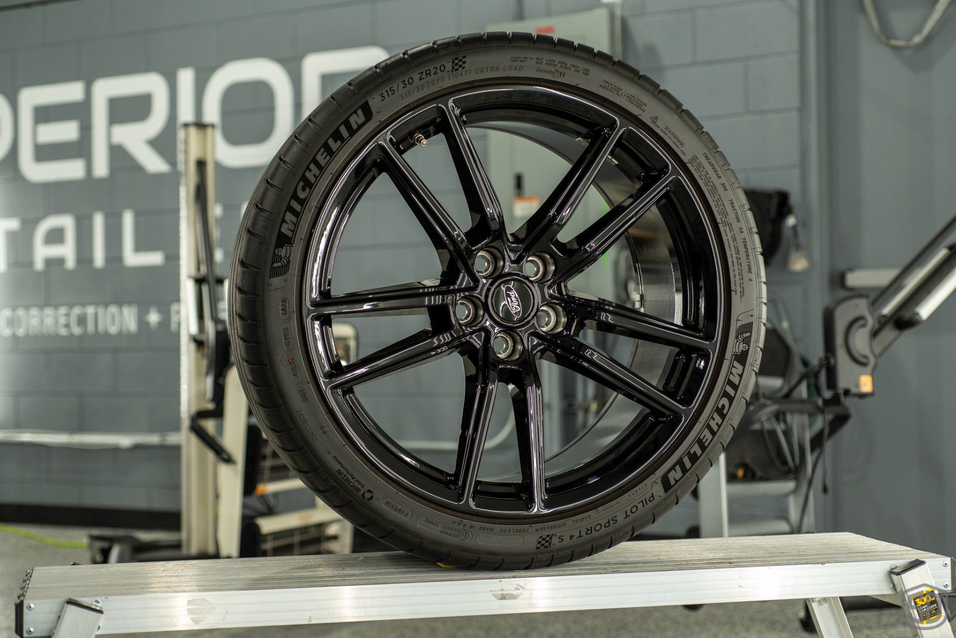 A black tire is sitting on top of a metal platform.