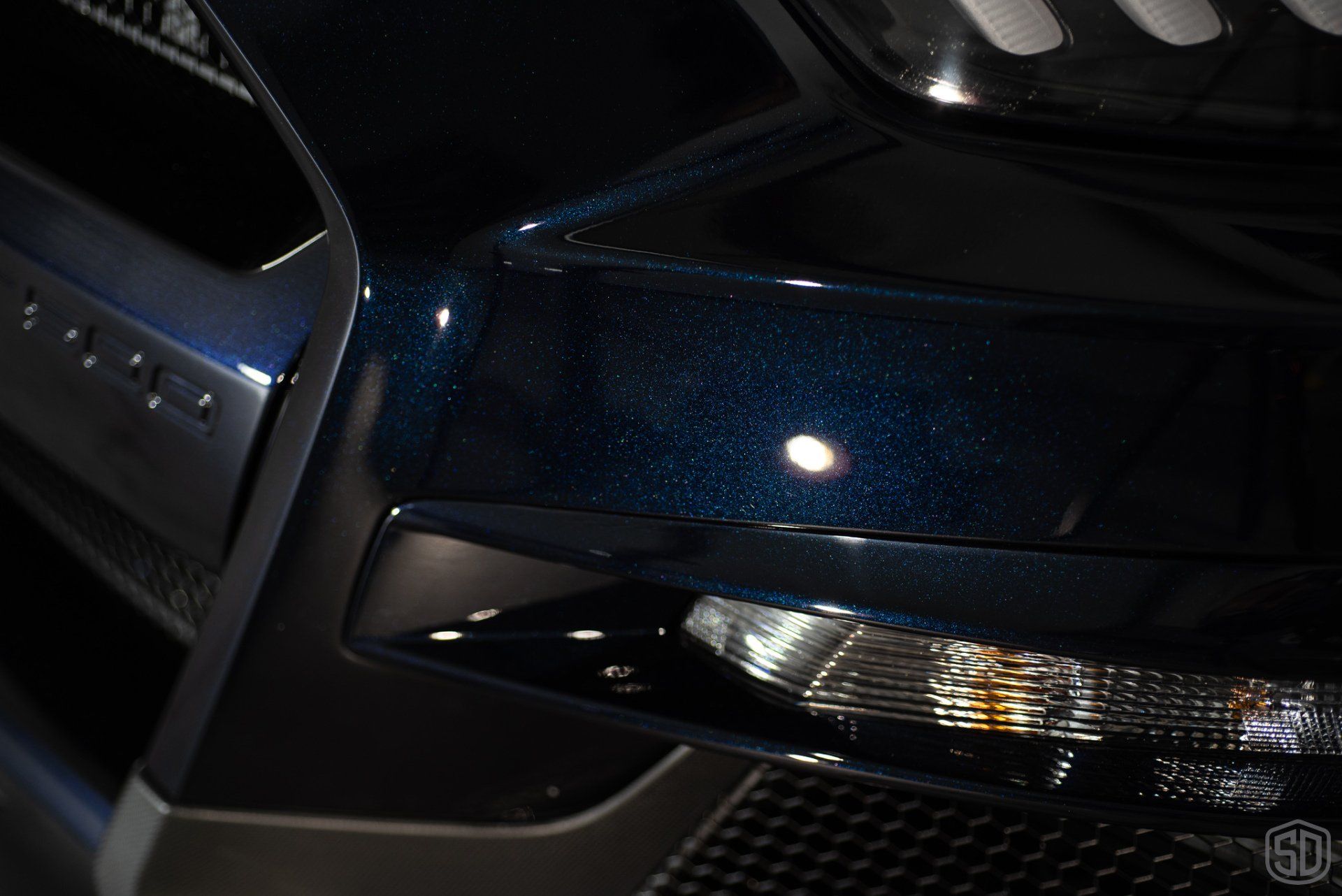 A close up of the front of a blue car