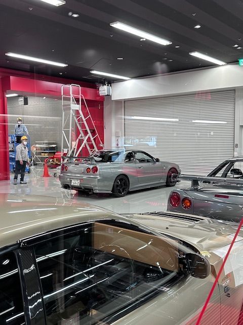 A row of cars are parked in a garage.