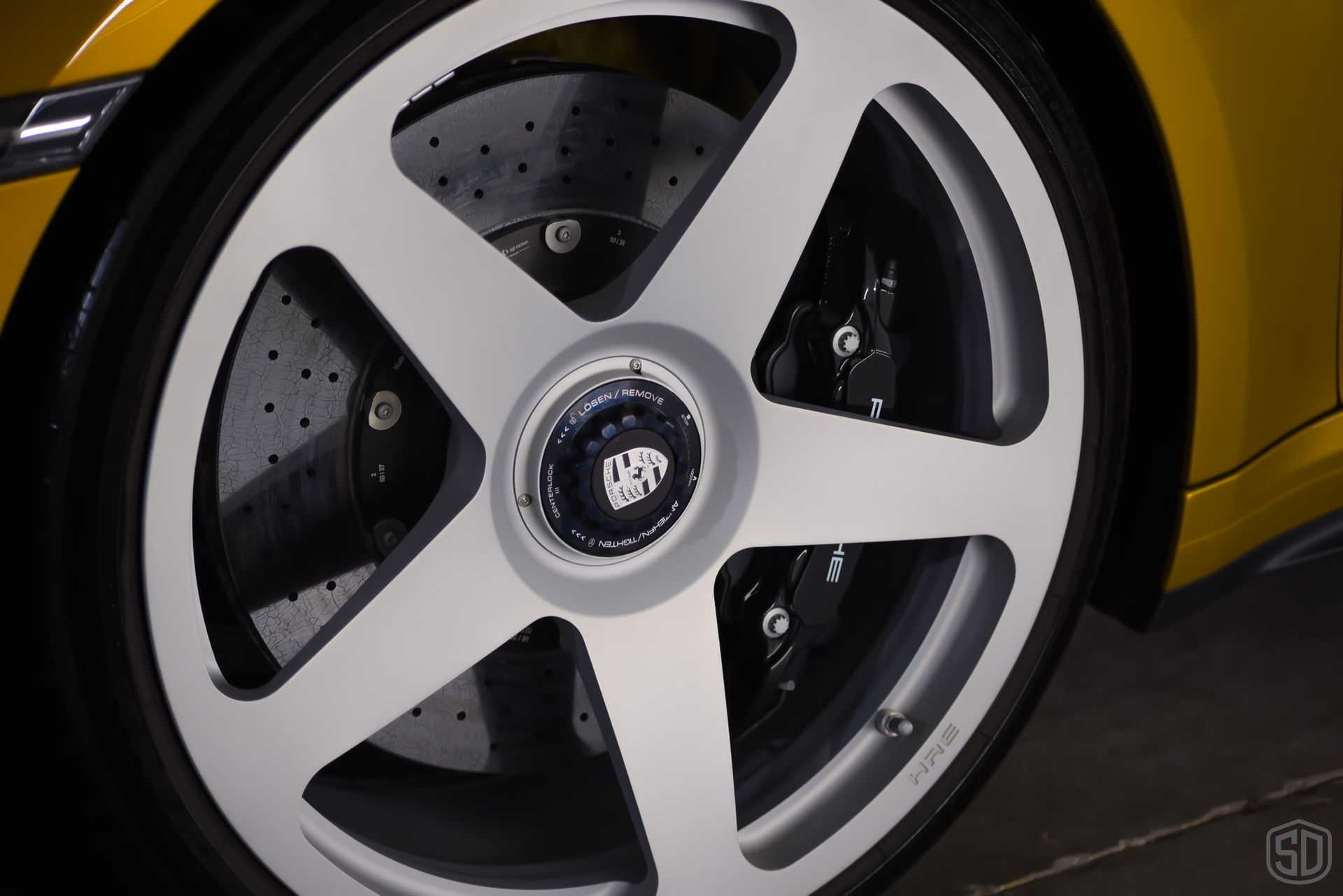 A close up of a wheel on a yellow car